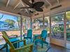 Relax in your screened porch with colorful Adirondack chairs and tropical garden views. The ceiling fan keeps you comfortable yearround.