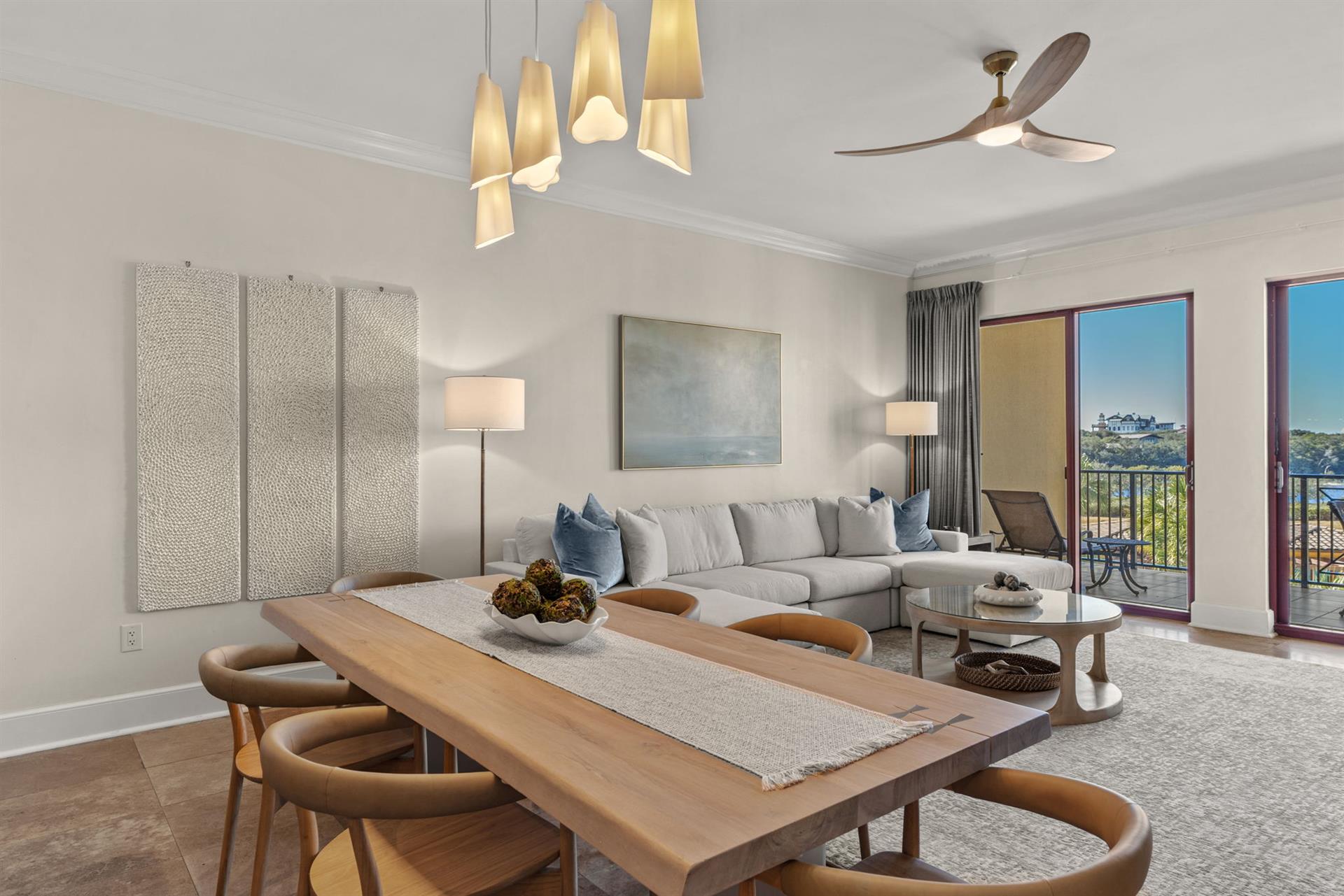 Relax in your sophisticated openconcept living space featuring elegant pendant lighting, plush seating, and stunning views from your private balcony.