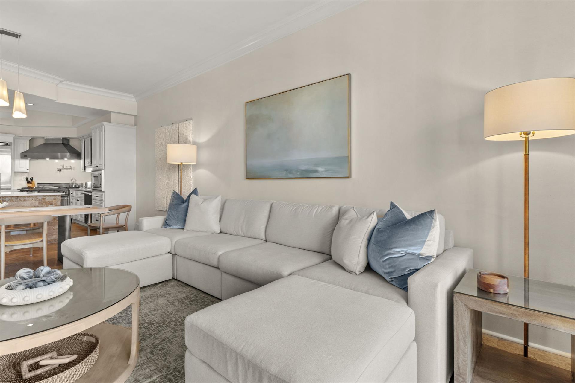 Sink into plush sectional seating with oceaninspired blue accents. Your openconcept space flows seamlessly to a modern kitchen.