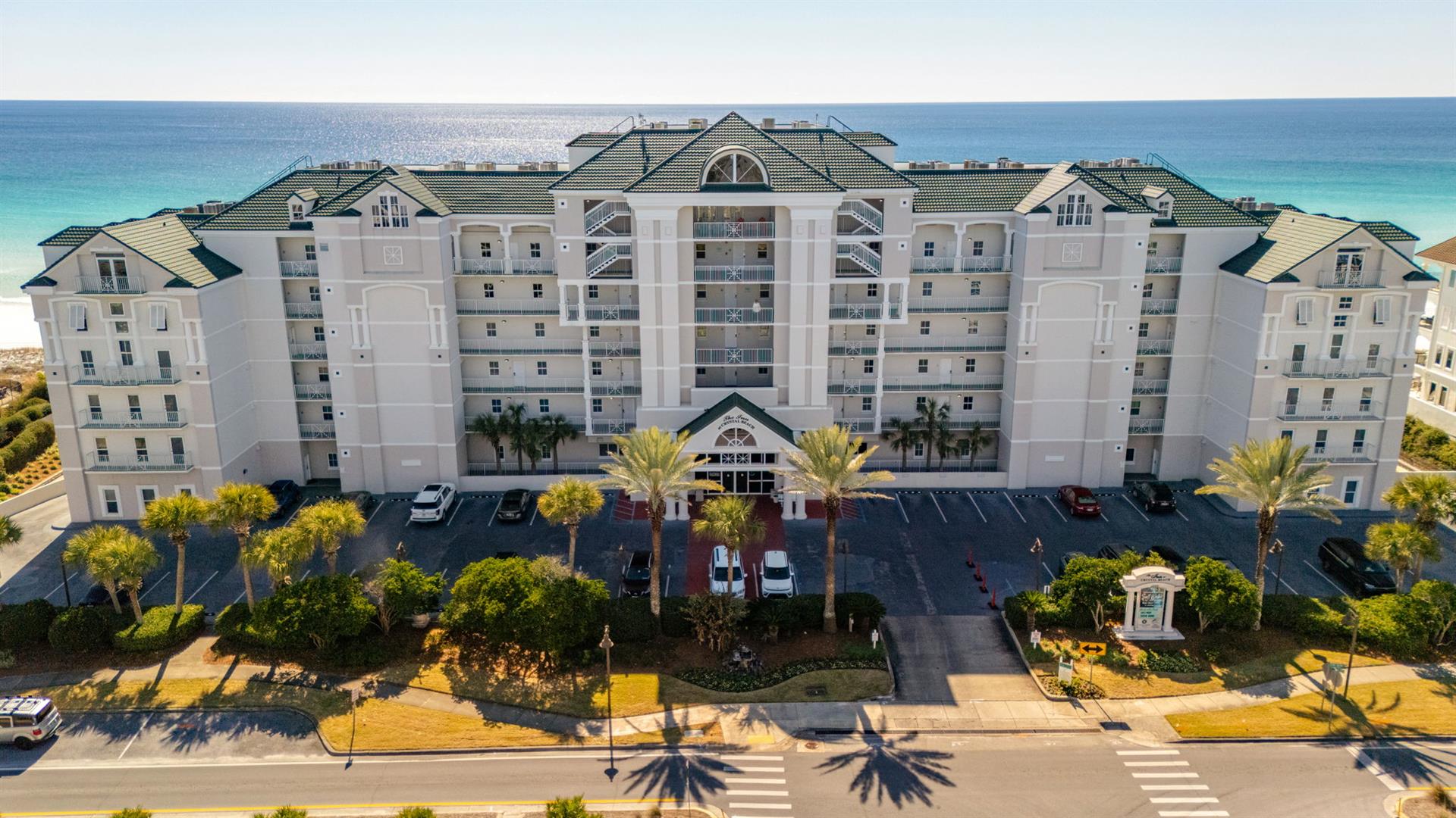 Beachfront resort with stunning turquoise waters just steps away. Multistory property offers convenient parking and tropical landscaping.