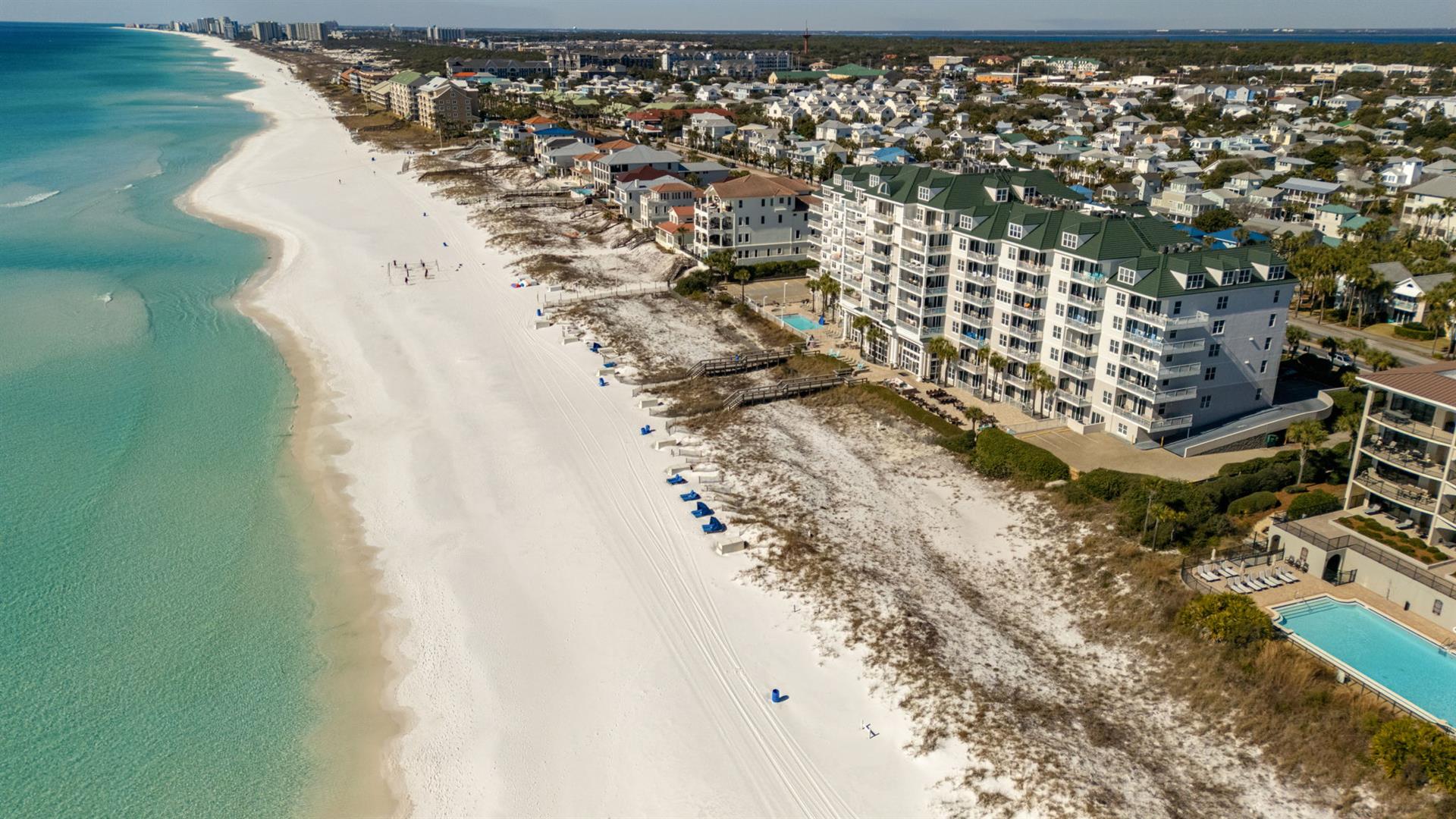Stunning beachfront property with pristine white sand beach and crystalclear turquoise waters stretching along the coastline.