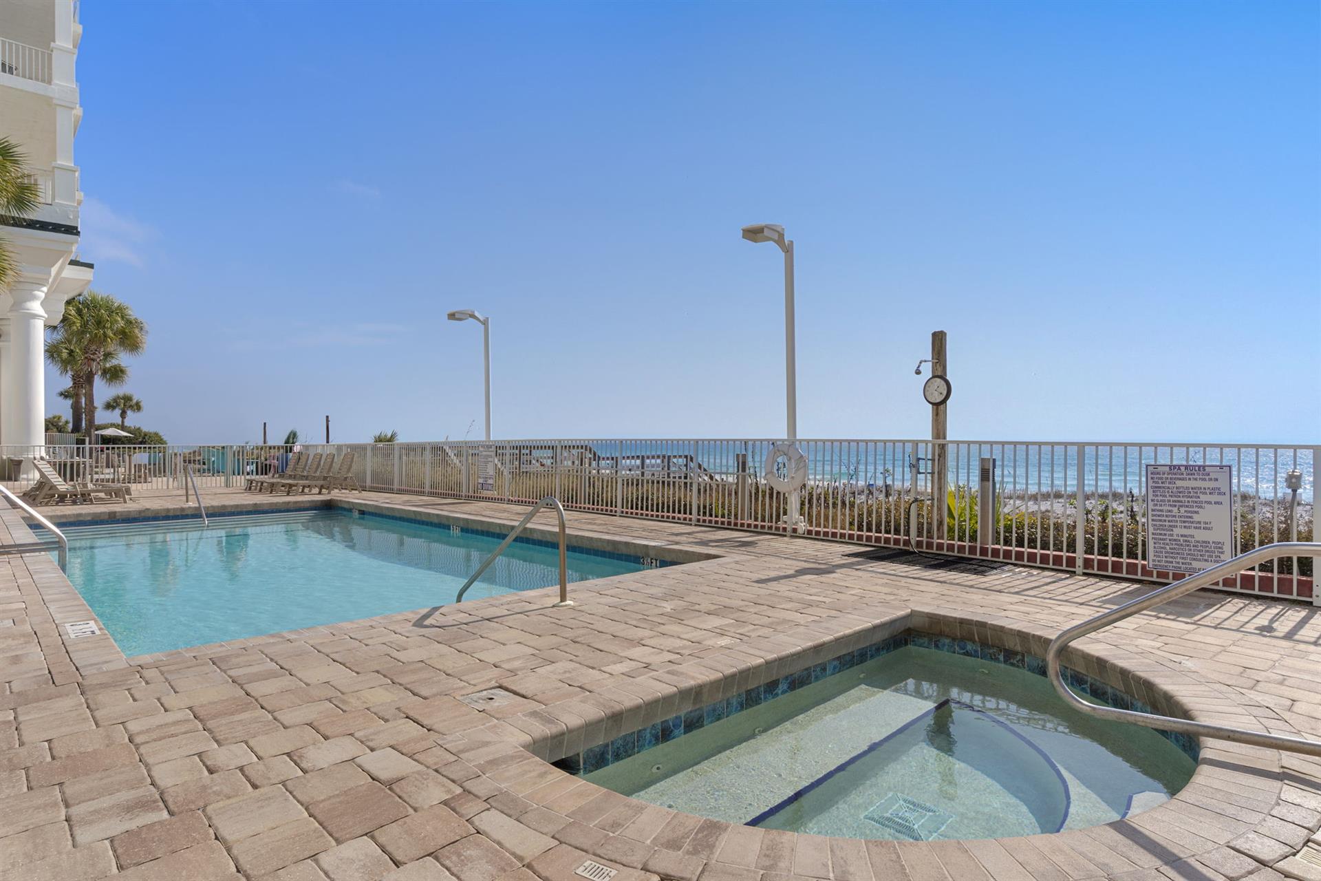 Crystalclear waters await in this gulf front community pool where palm trees sway and endless blue sky meets the horizon.