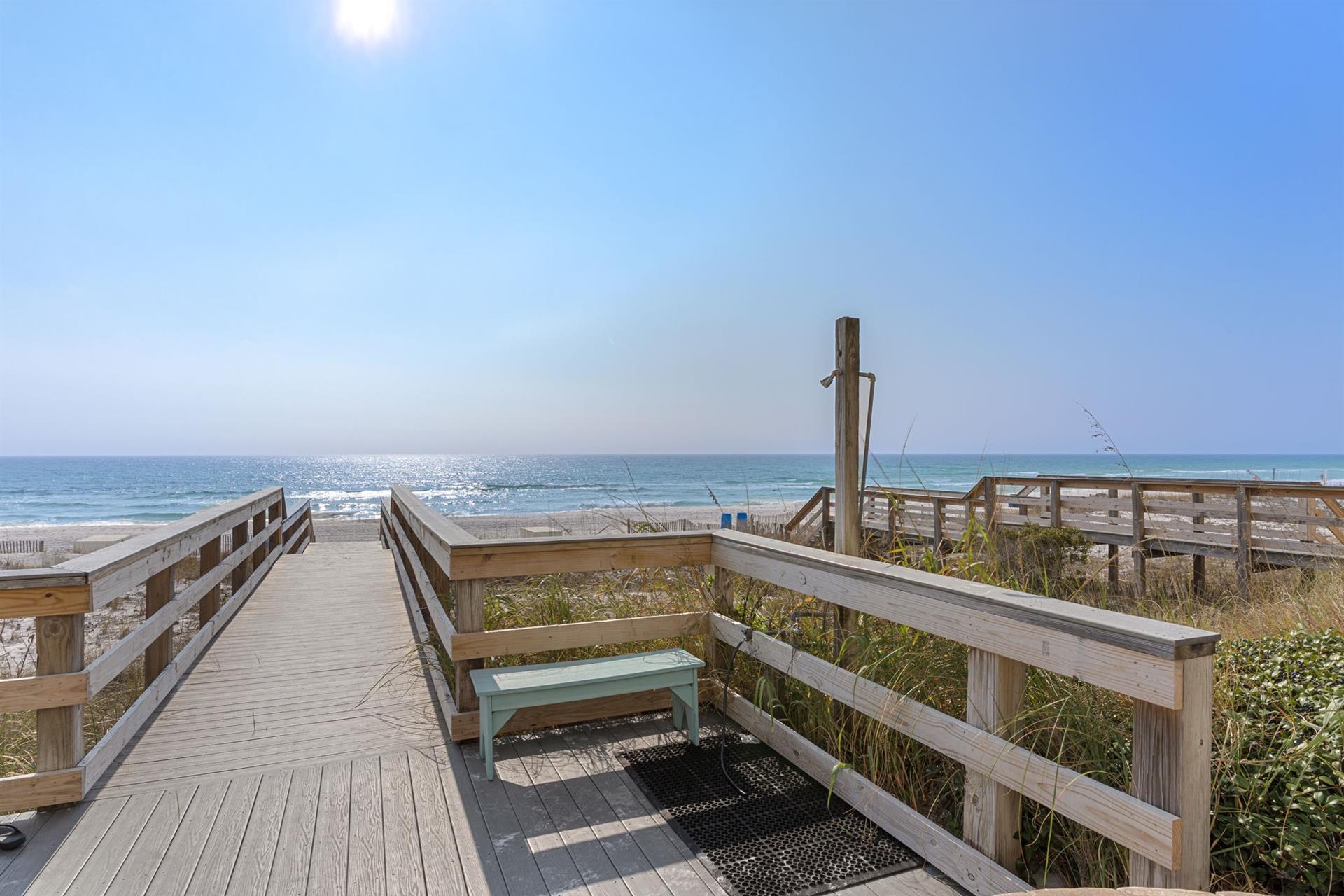 Wooden boardwalk with showers to wash off after a long, relaxing beach day.