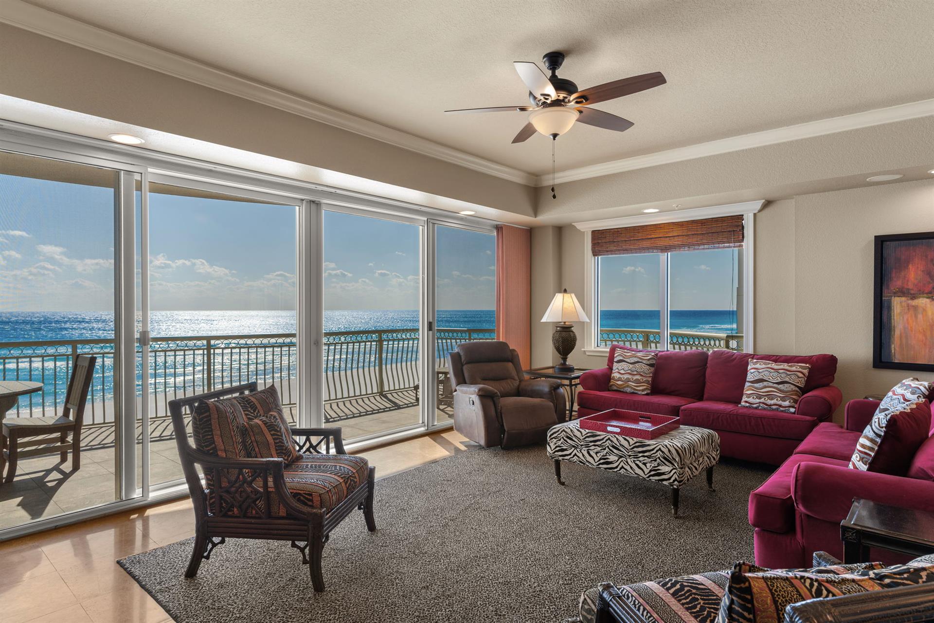 Sink into plush seating while waves sparkle just beyond your floortoceiling windows in this oceanfront living space.