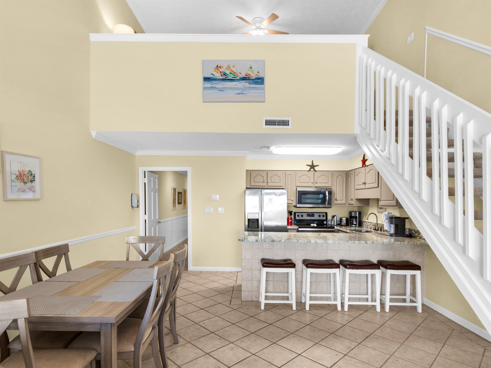 Gather around the kitchen island for coffee or explore the open layout connecting dining and kitchen spaces perfectly for your stay.