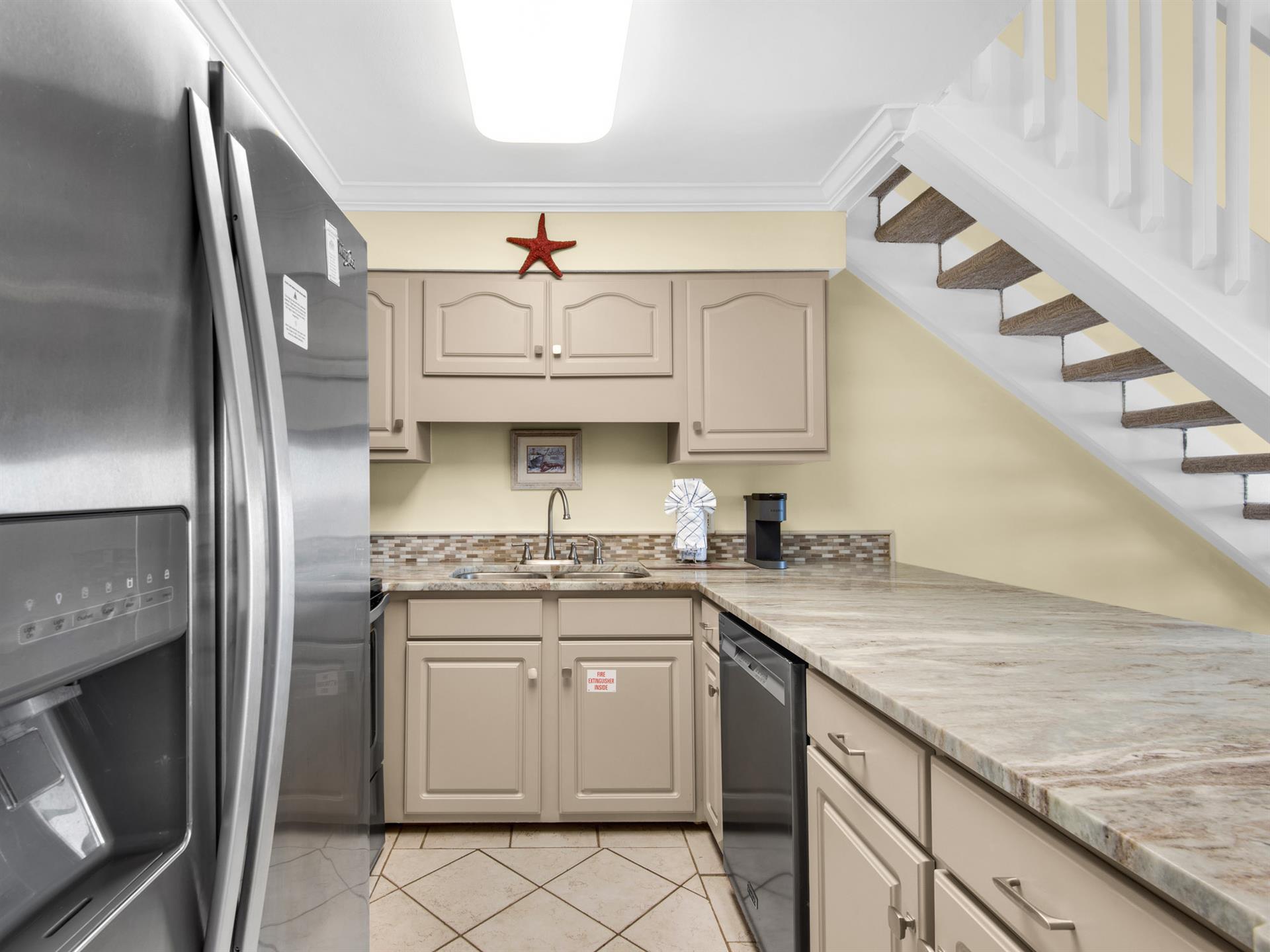 Your compact kitchen features granite countertops, stainless steel appliances, and thoughtful understair design maximizing every inch of space.