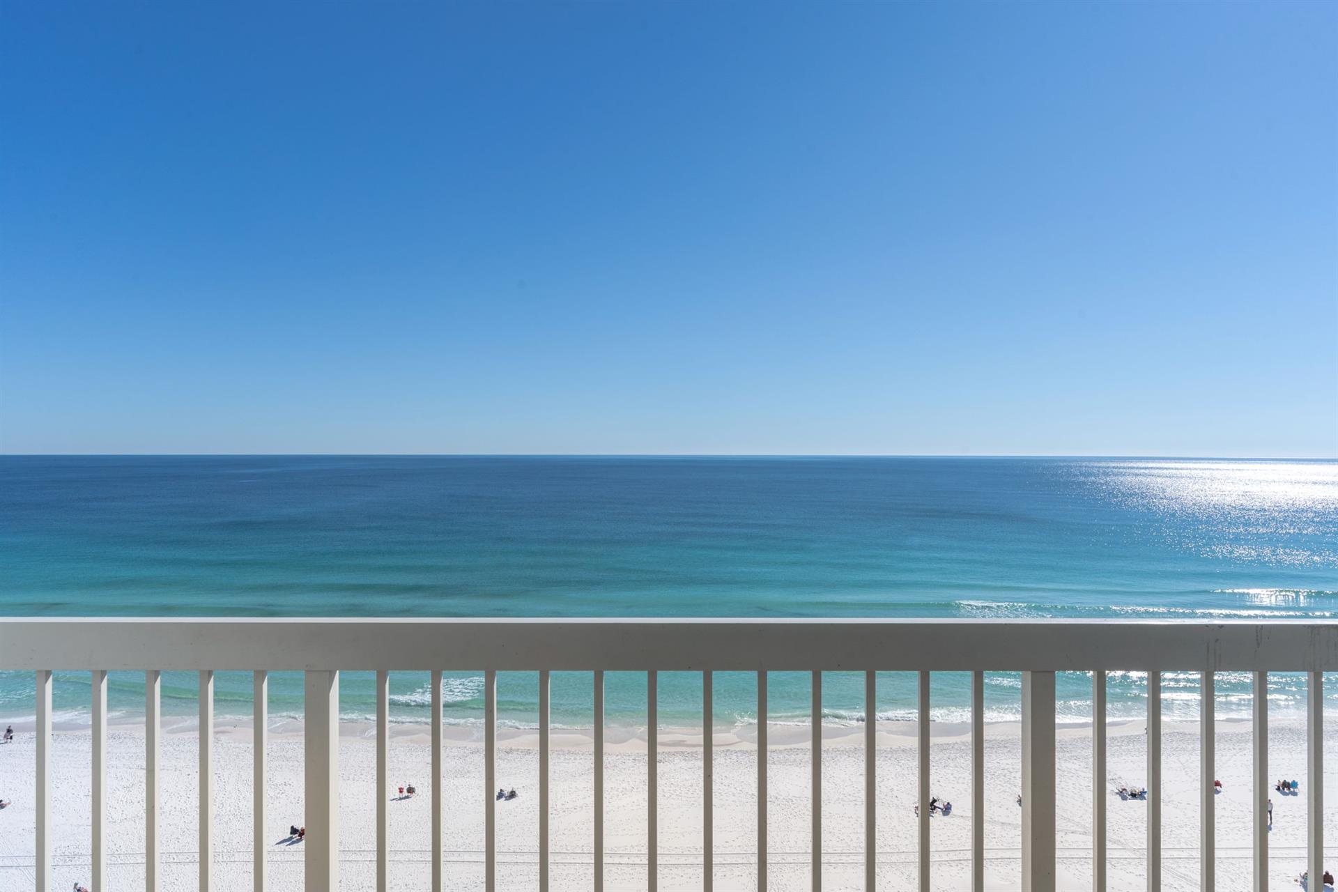 Pristine white sand beach and turquoise waters stretch endlessly from this oceanfront balcony, creating the perfect backdrop for relaxation.