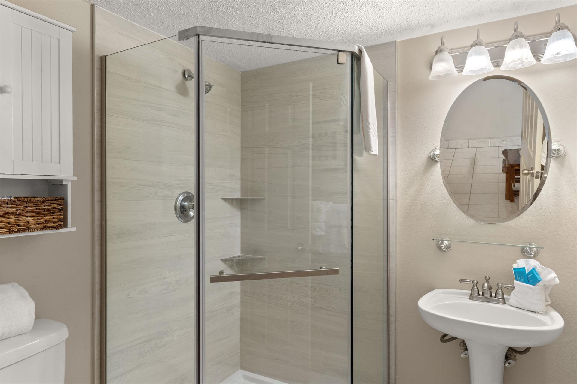 Freshen up in the elegant guest bathroom with a spacious glass shower