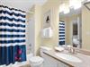 Your private bathroom features a relaxing tubshower combo with nautical charm, plus soft towels and coastal décor for your comfort.
