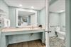 Bathroom vanity counter with large mirror