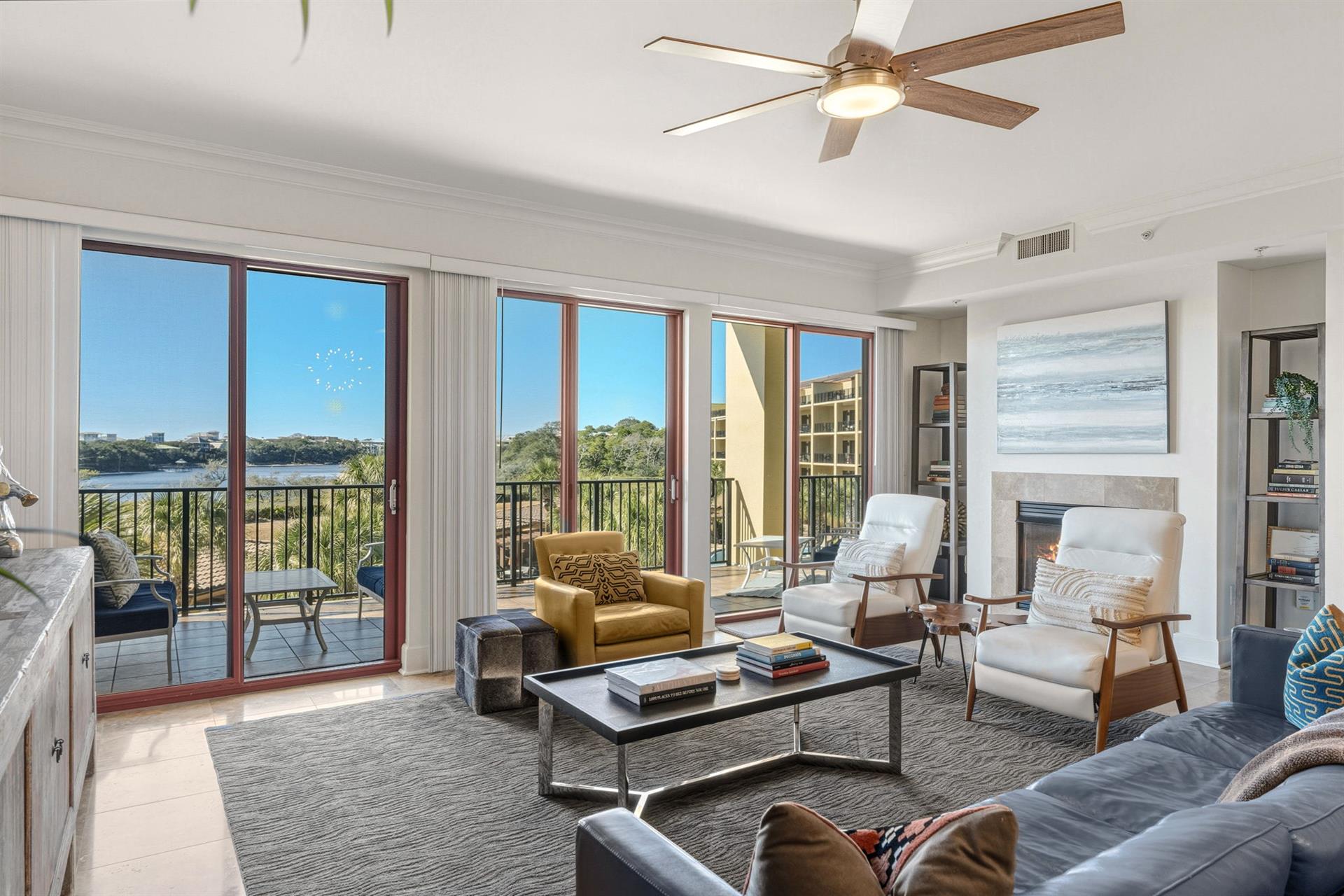 Sink into plush seating while enjoying stunning gulf and lake views through floortoceiling windows. Your spacious living room features modern comfort with a cozy fireplace.