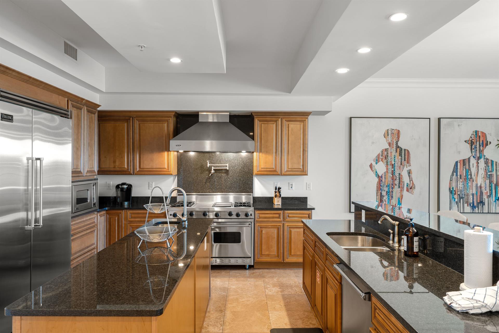 Your gourmet kitchen awaits with granite countertops, stainless appliances, and warm wood cabinets—perfect for creating memorable meals together.
