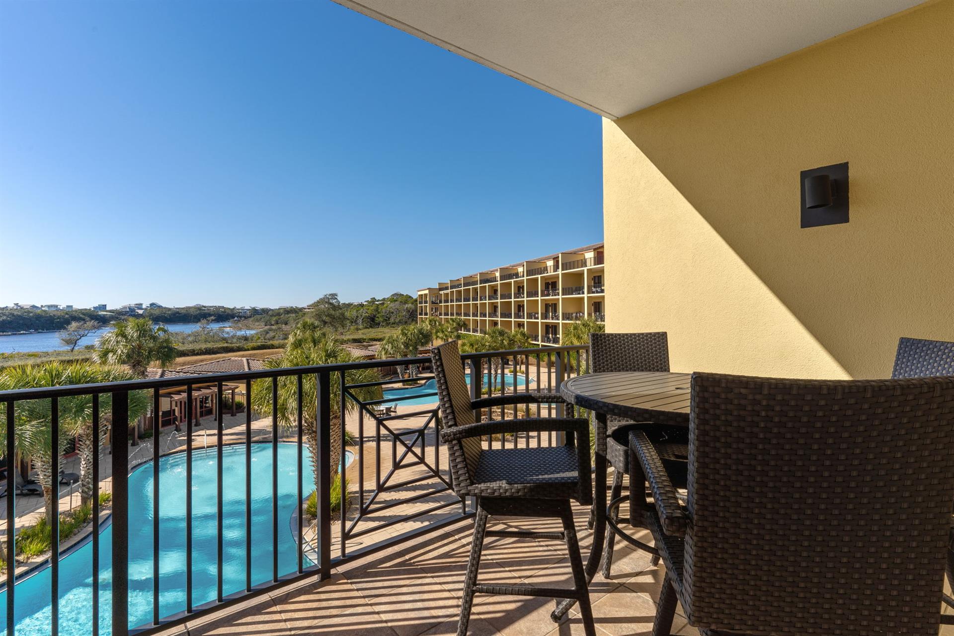 Your private balcony offers stunning pool and water views with comfortable outdoor dining furniture for morning coffee or evening relaxation.