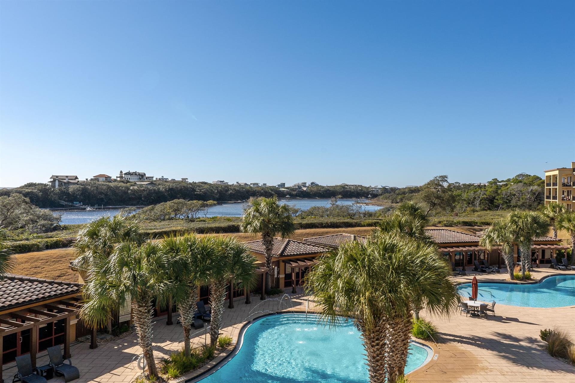 Coastal retreat with lake views and palmlined pool area surrounded by natural wetlands.