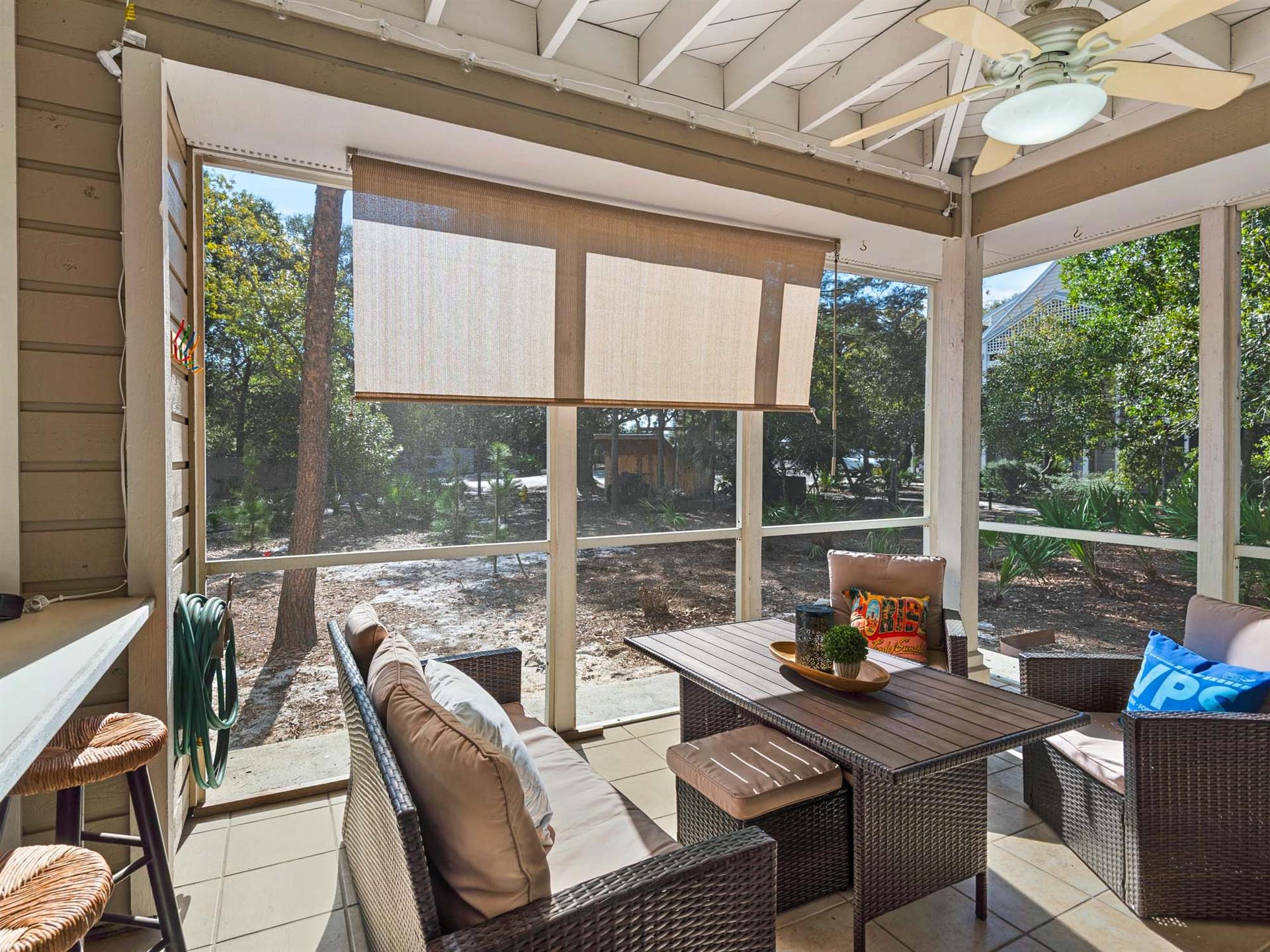 Your private screened patio creates the perfect outdoor retreat with comfortable seating and peaceful garden views.
