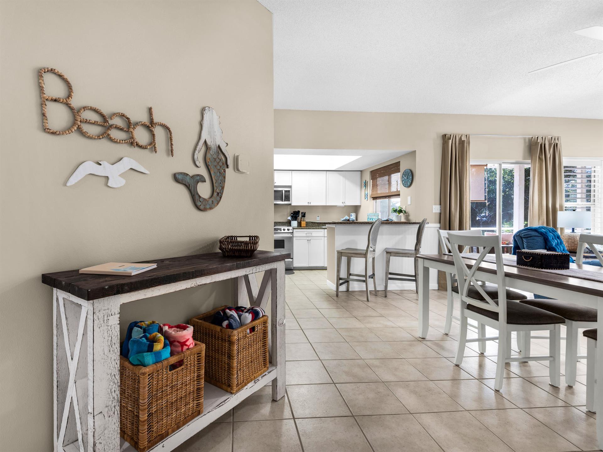 Gather around your spacious dining table with coastal charm, where beachthemed décor and organized storage create the perfect spot for family meals.