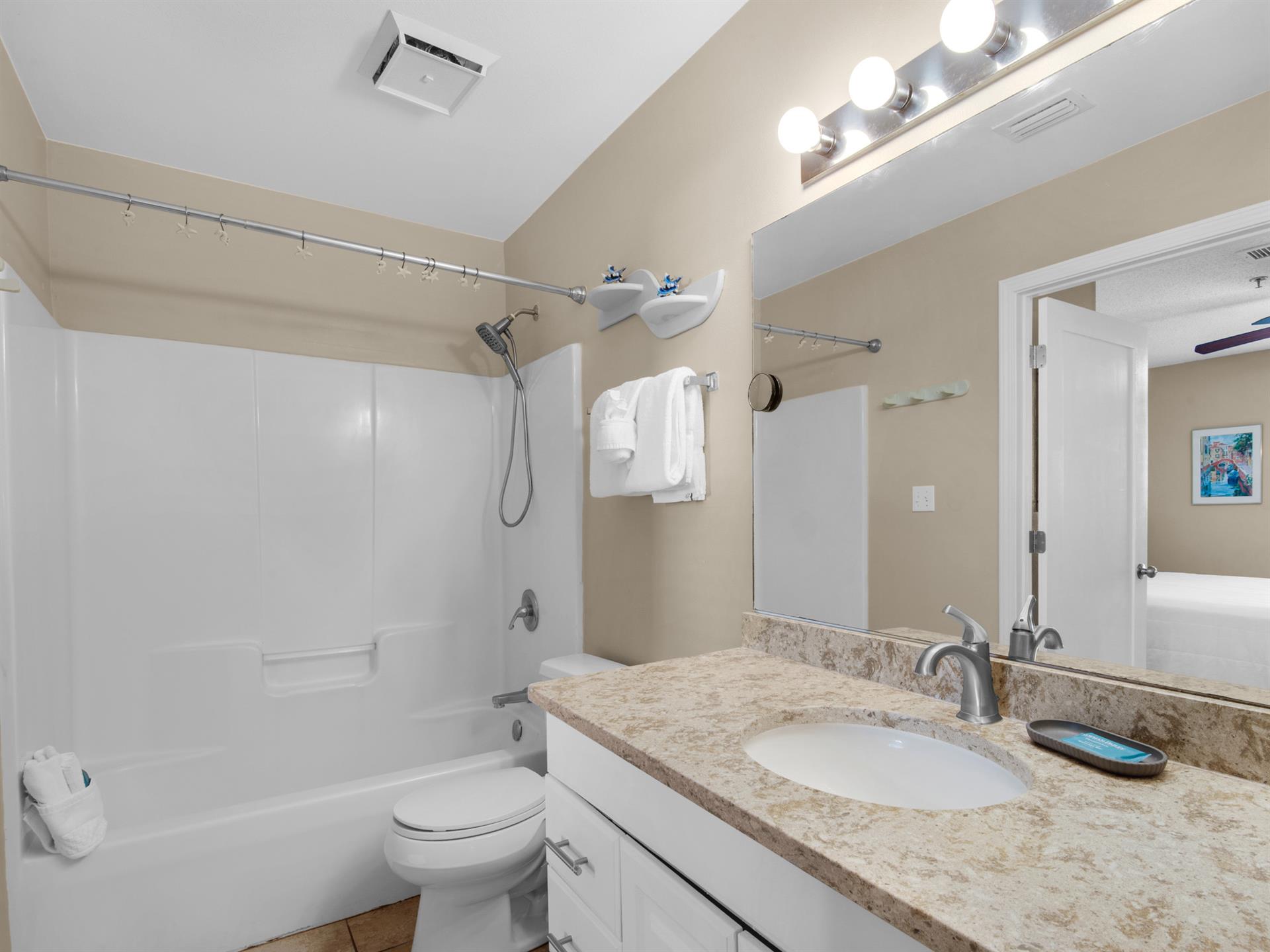 The bathroom features fresh towels, and a soothing tubshower combo for unwinding after your adventures.