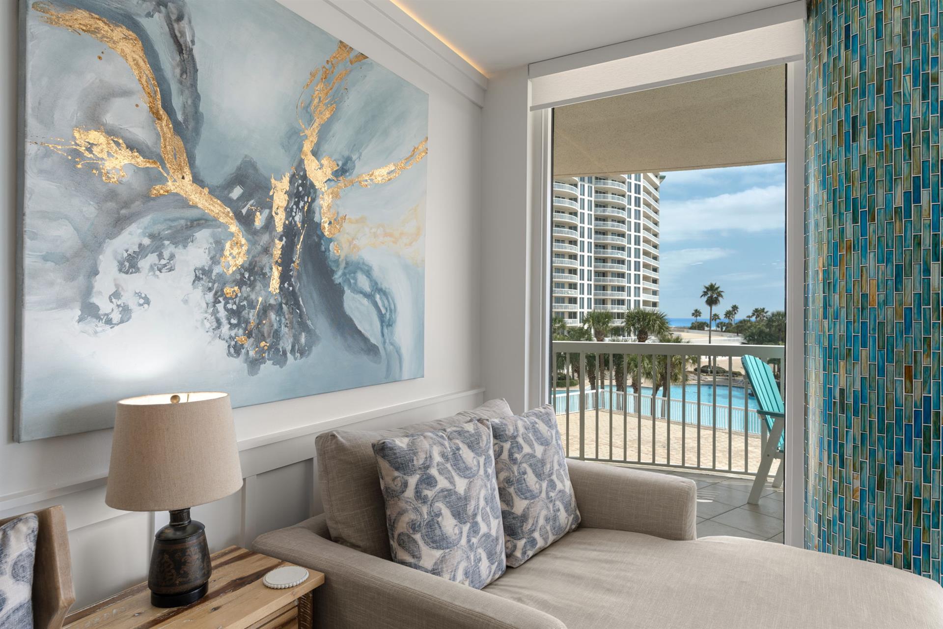 Sink into plush seating while enjoying your stunning poolside view through floortoceiling windows in this elegantly appointed coastal retreat.
