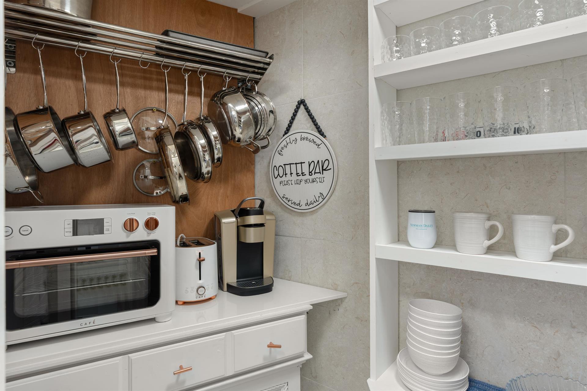 Your fully equipped kitchen features hanging cookware, coffee maker, and organized shelving for effortless meal preparation.