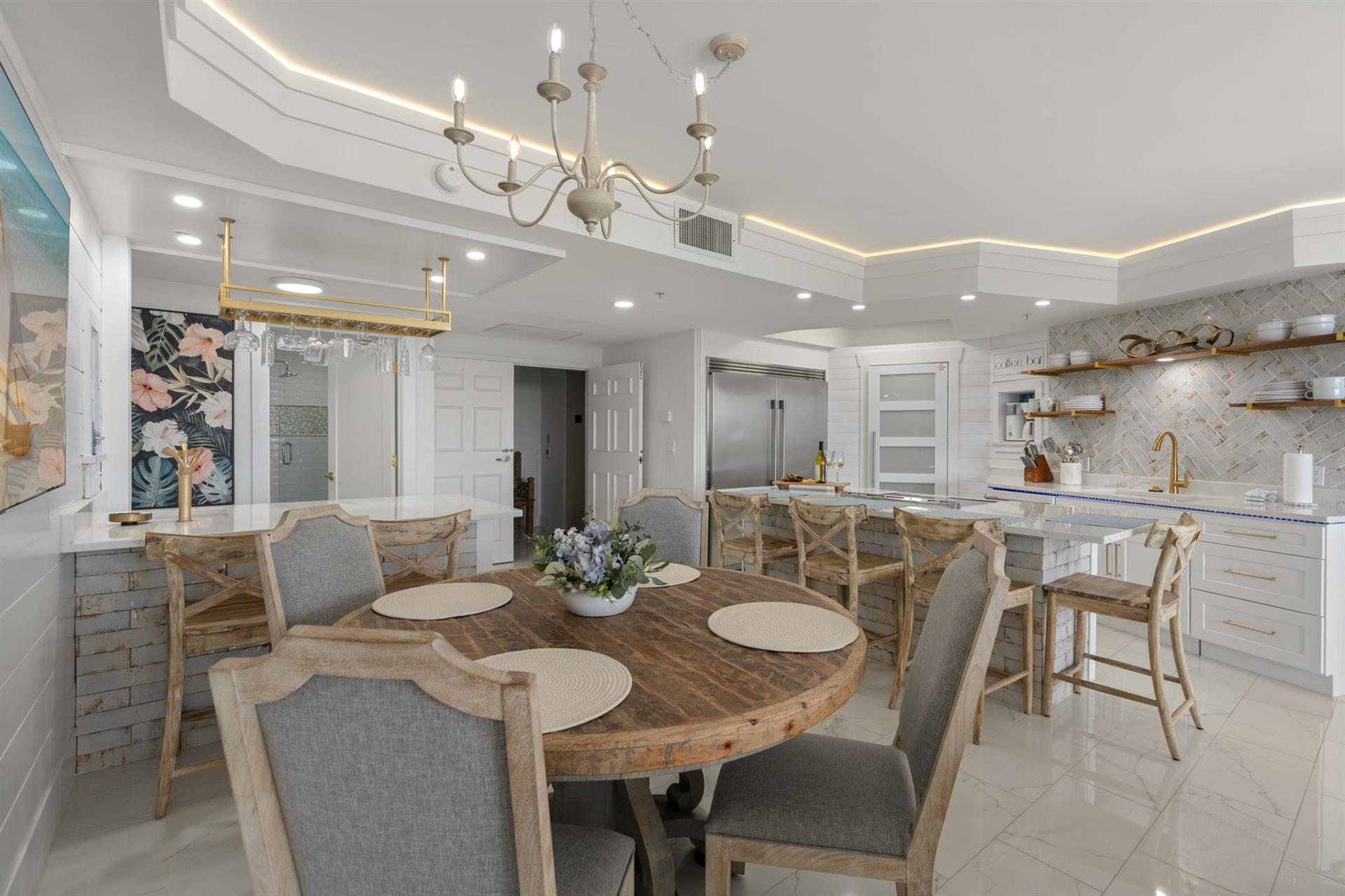 Your elegant open dining and kitchen area features beautiful wood accents, marble countertops, and sophisticated lighting perfect for memorable meals.