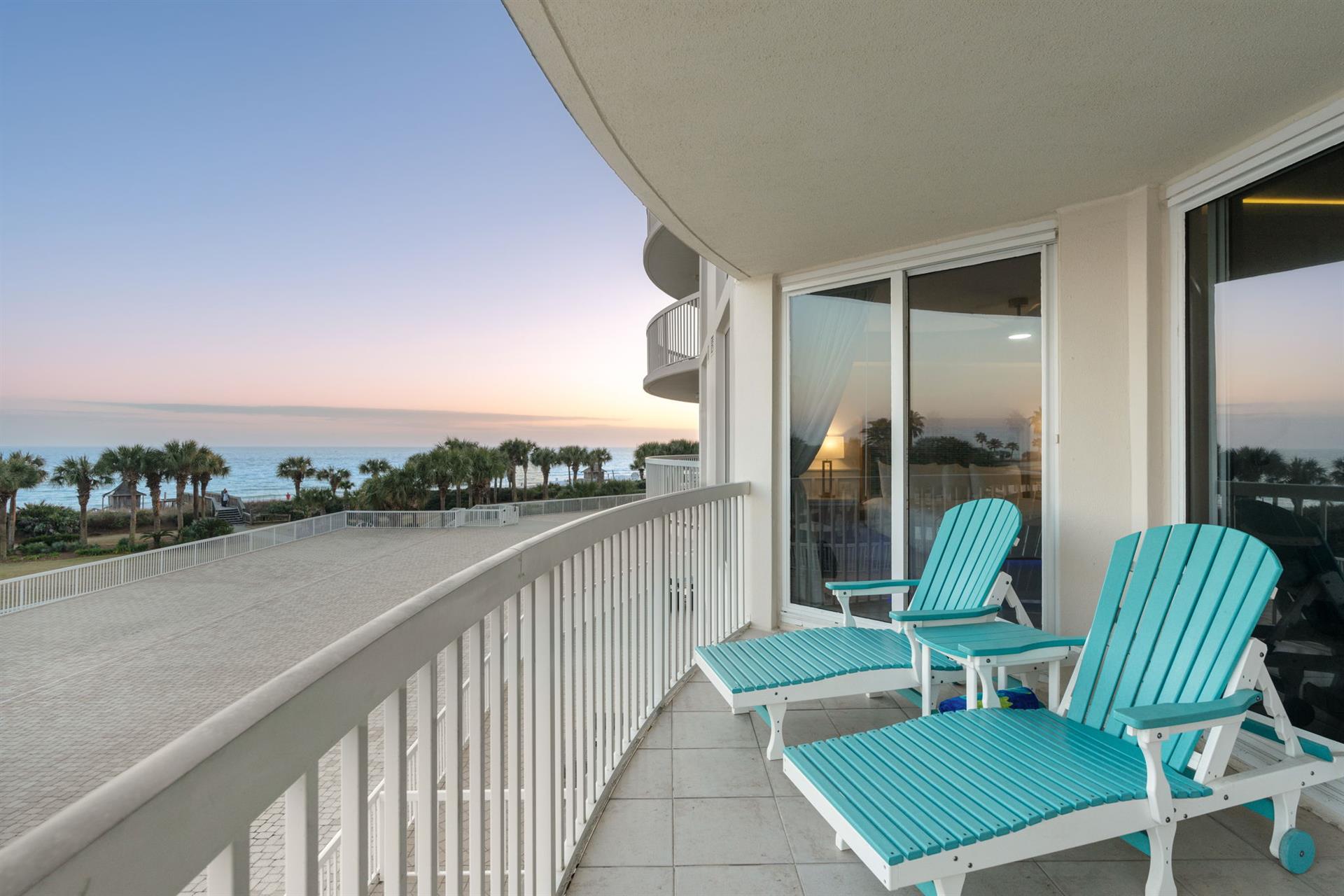 Wake up to stunning ocean views from your private balcony, where turquoise lounge chairs await your morning coffee ritual.