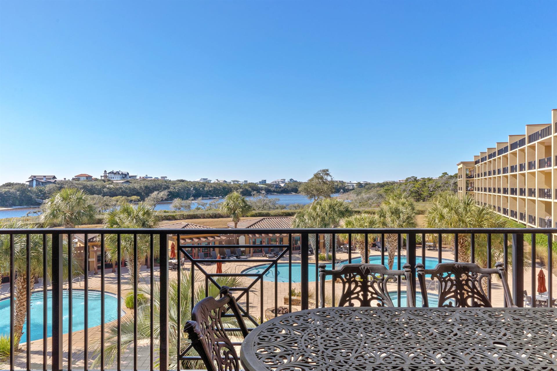 Your private balcony offers stunning pool and water views, perfect for morning coffee or evening relaxation with gentle breezes.