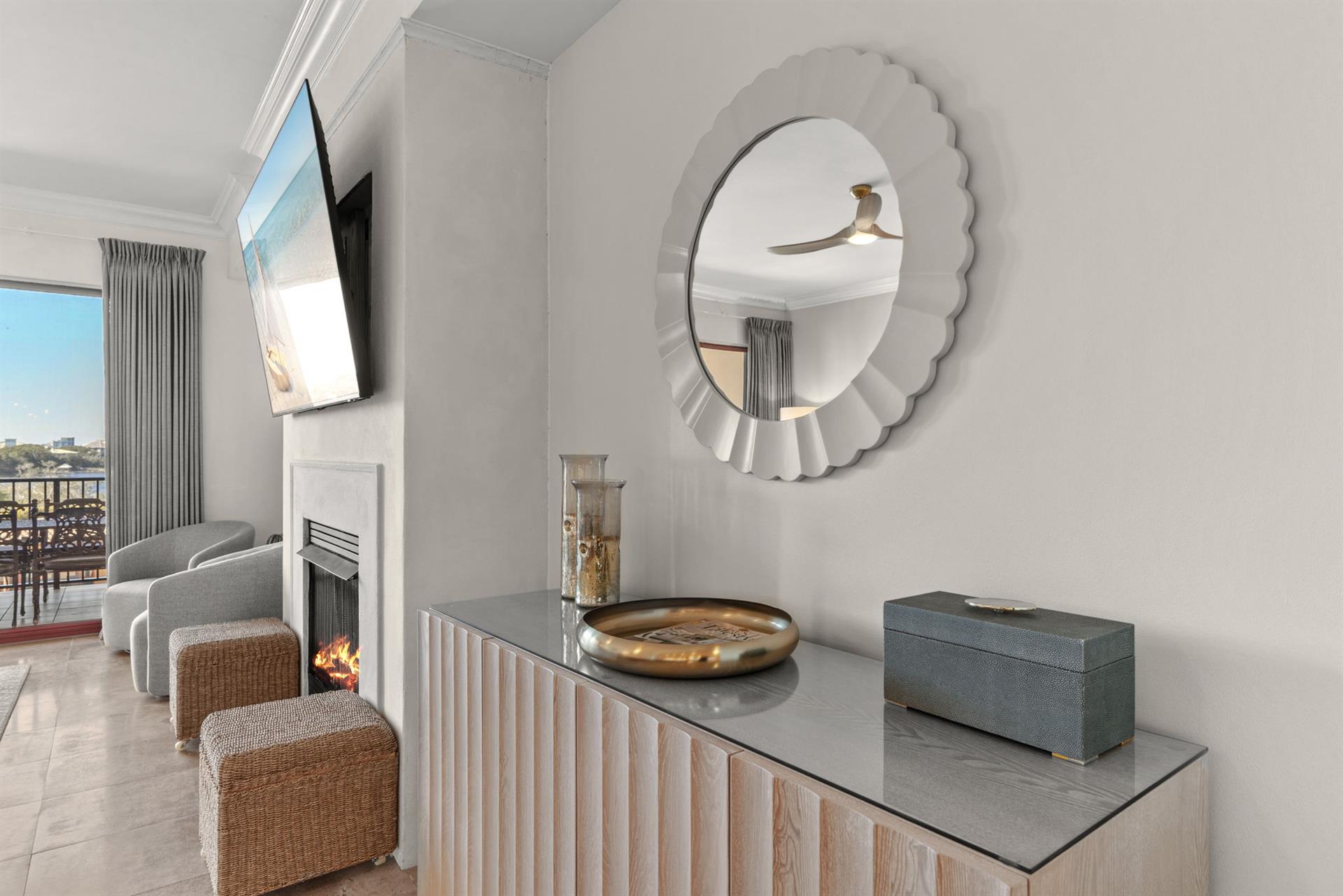 Unwind in your elegant living space with stunning city views, cozy fireplace, and sophisticated coastal decor.