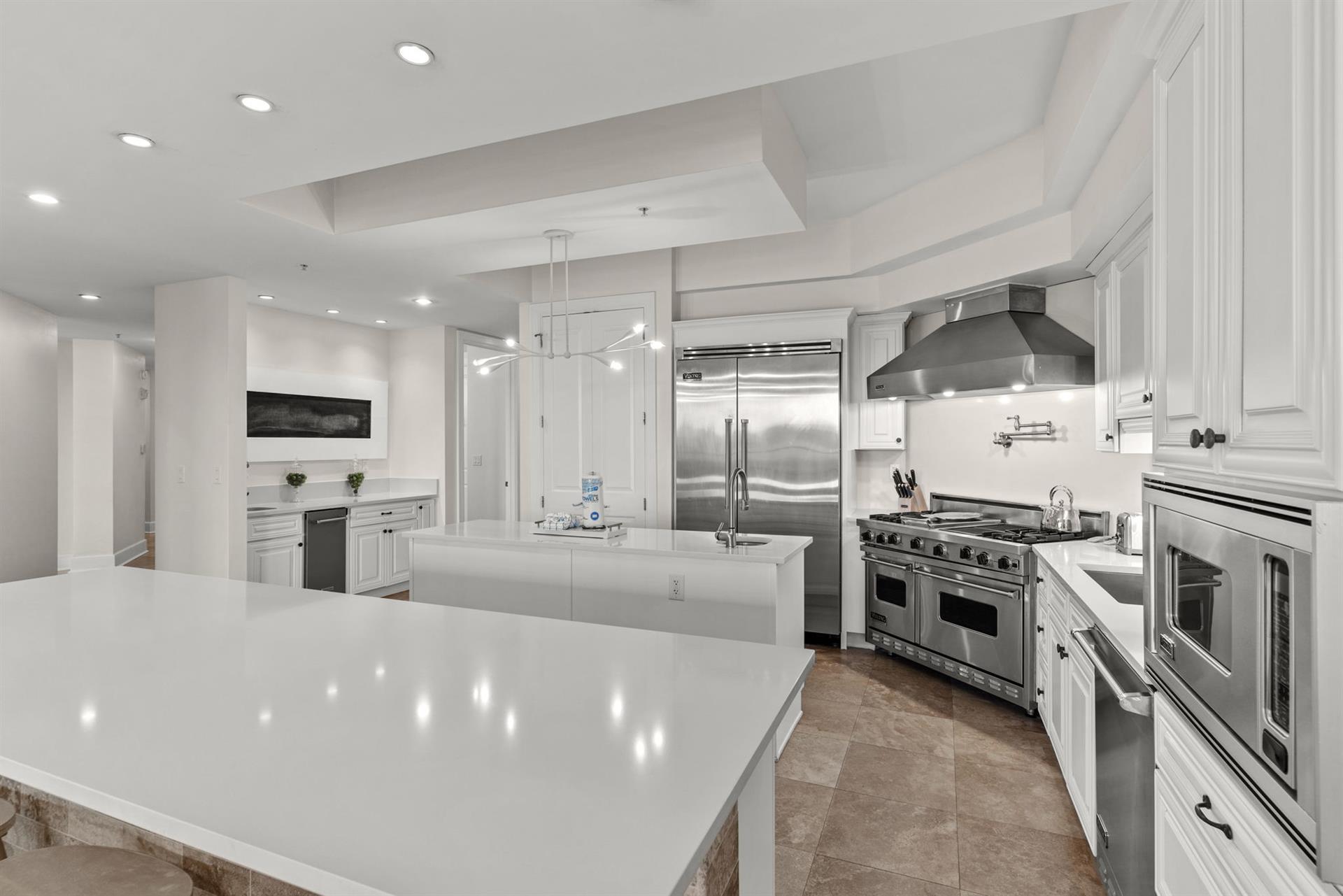 Your dream kitchen awaits with pristine marble countertops, professionalgrade appliances, and bright white cabinetry perfect for creating memorable meals.