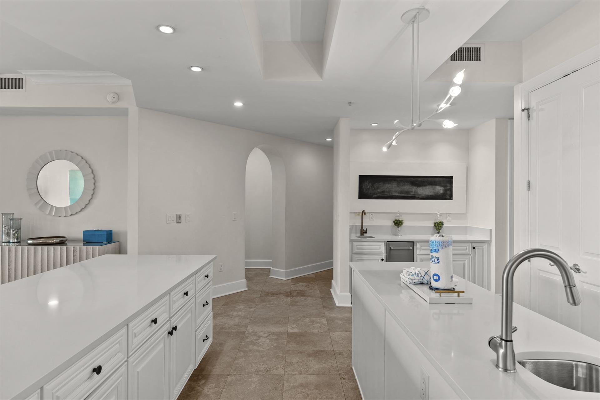 Your sleek white kitchen features modern appliances and pristine countertops, perfect for preparing memorable meals during your stay.