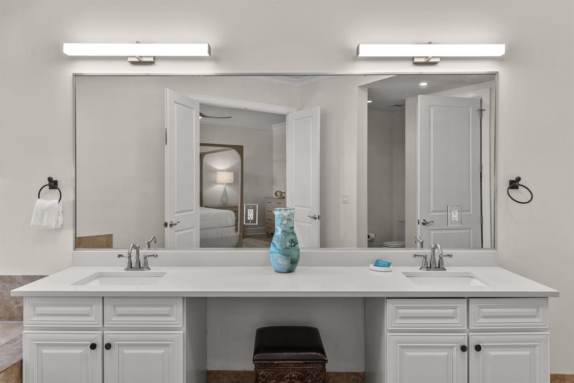 Your spacious double vanity offers plenty of room for two, with elegant lighting and modern fixtures for your morning routine.
