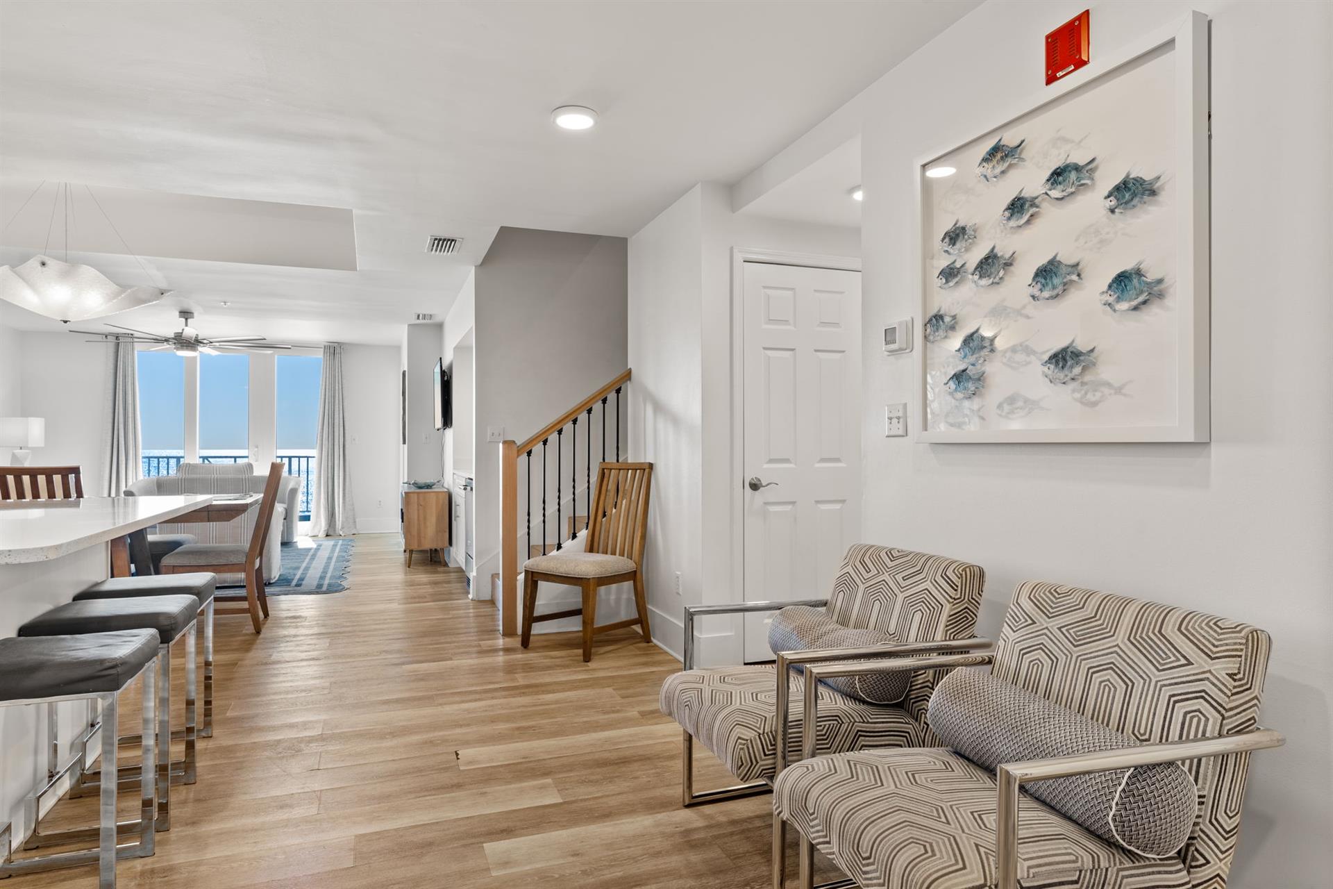 Relax in your bright living space with coastal artwork and stylish seating.