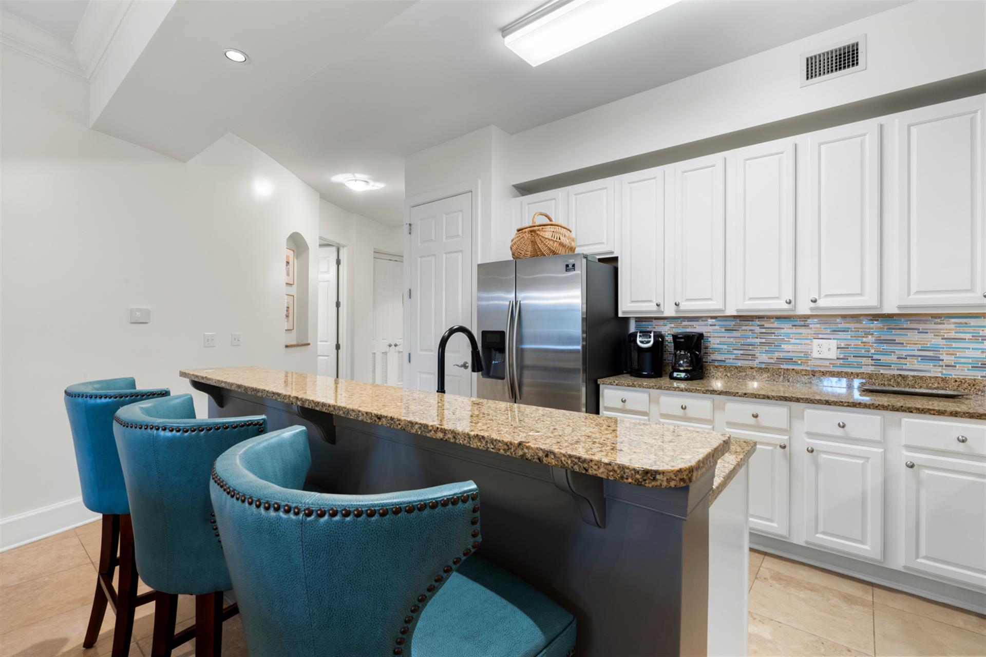 Bright, open kitchen with ample space to prepare family meals in a breezy, coastal setting.