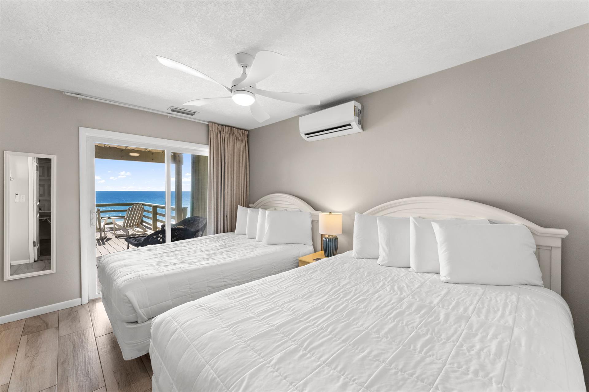 Bedroom 3 offers stunning Gulf views from the comfortable queen beds, with direct balcony access to enjoy morning coffee overlooking the sea.