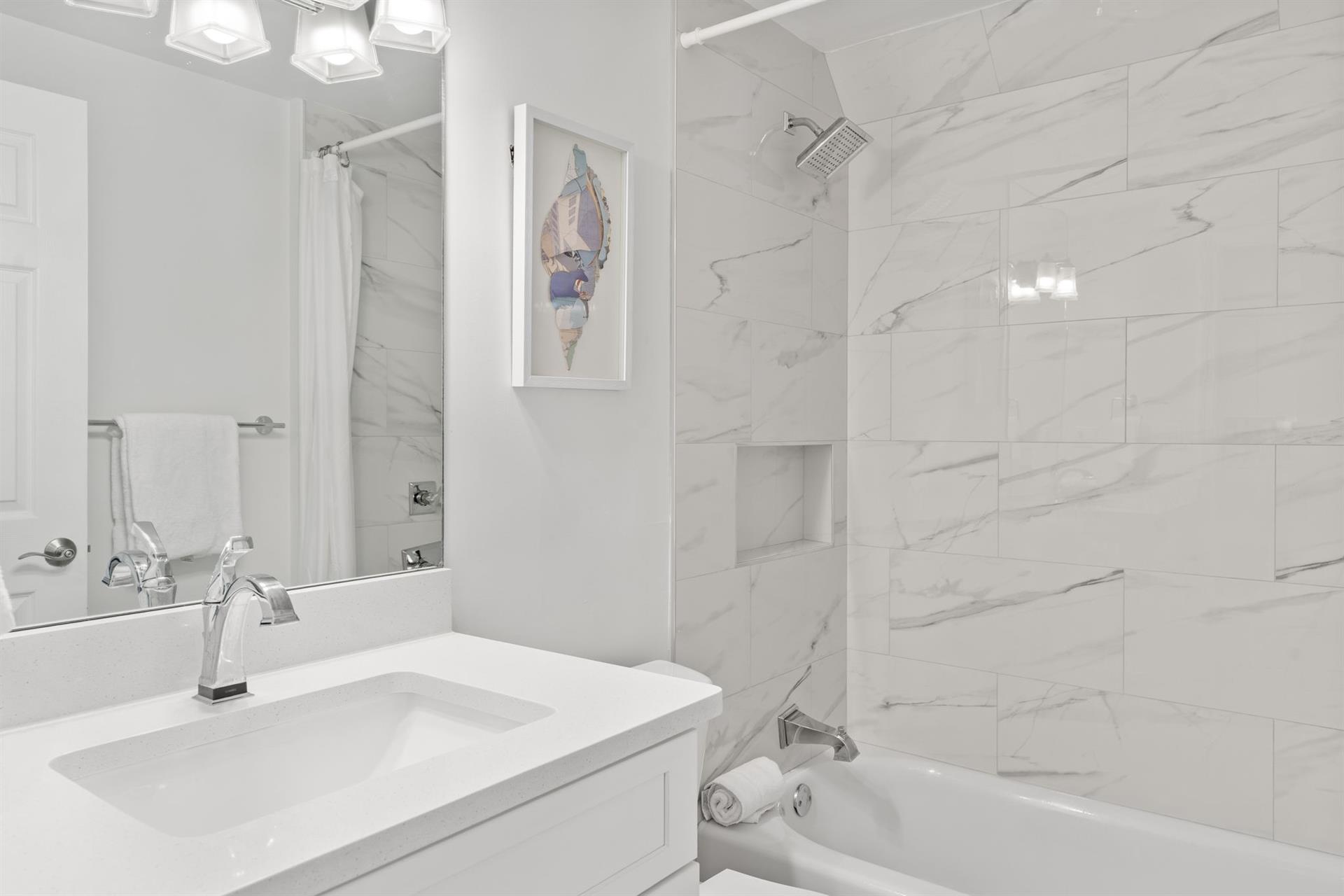 This marble bathroom features a luxurious soaking tub and shower combo.