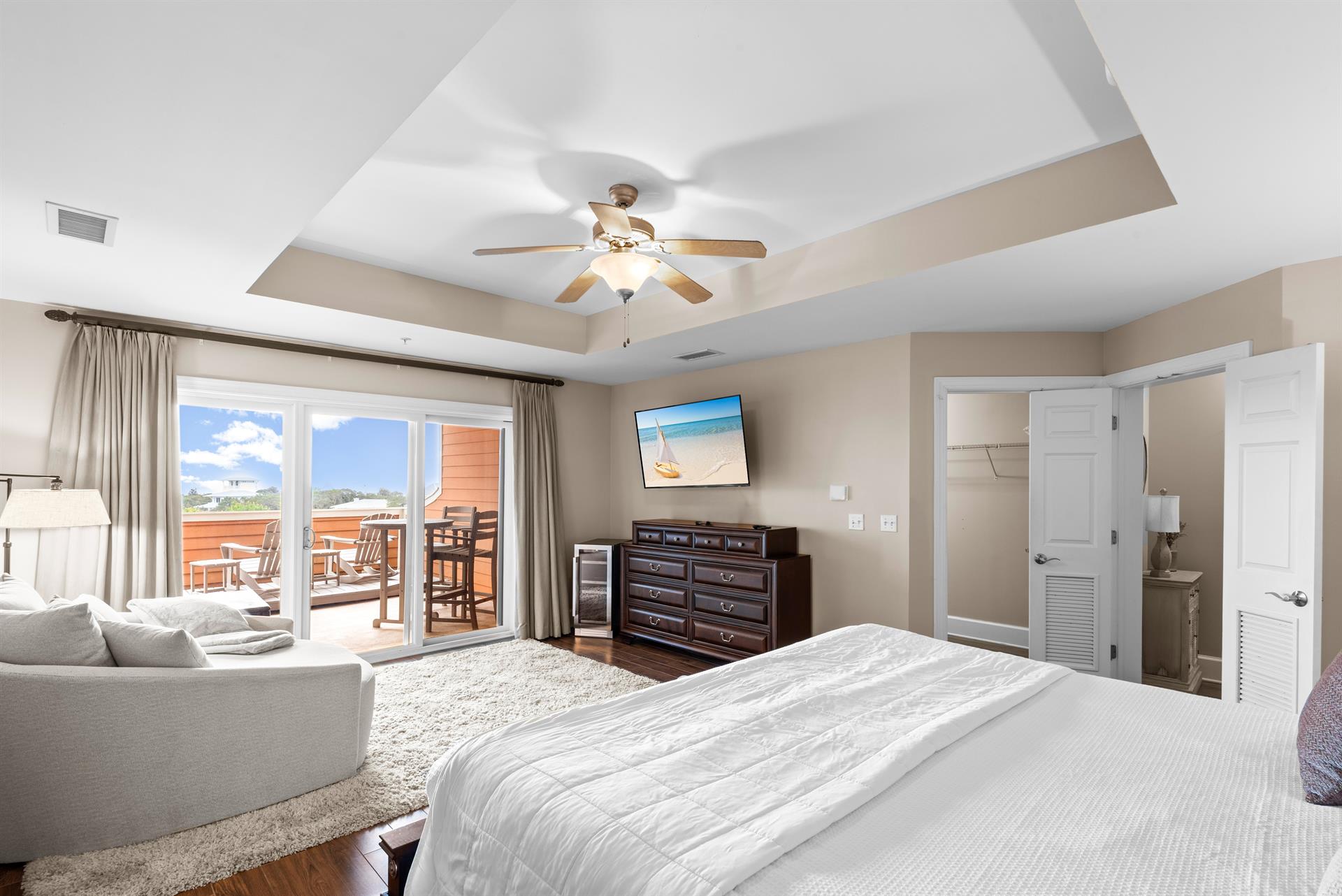 Spacious master suite with private balcony access and cozy seating area—perfect for morning coffee or evening relaxation.