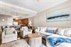 Unwind in this spacious living area where plush seating and coastal artwork create the perfect retreat after exploring.