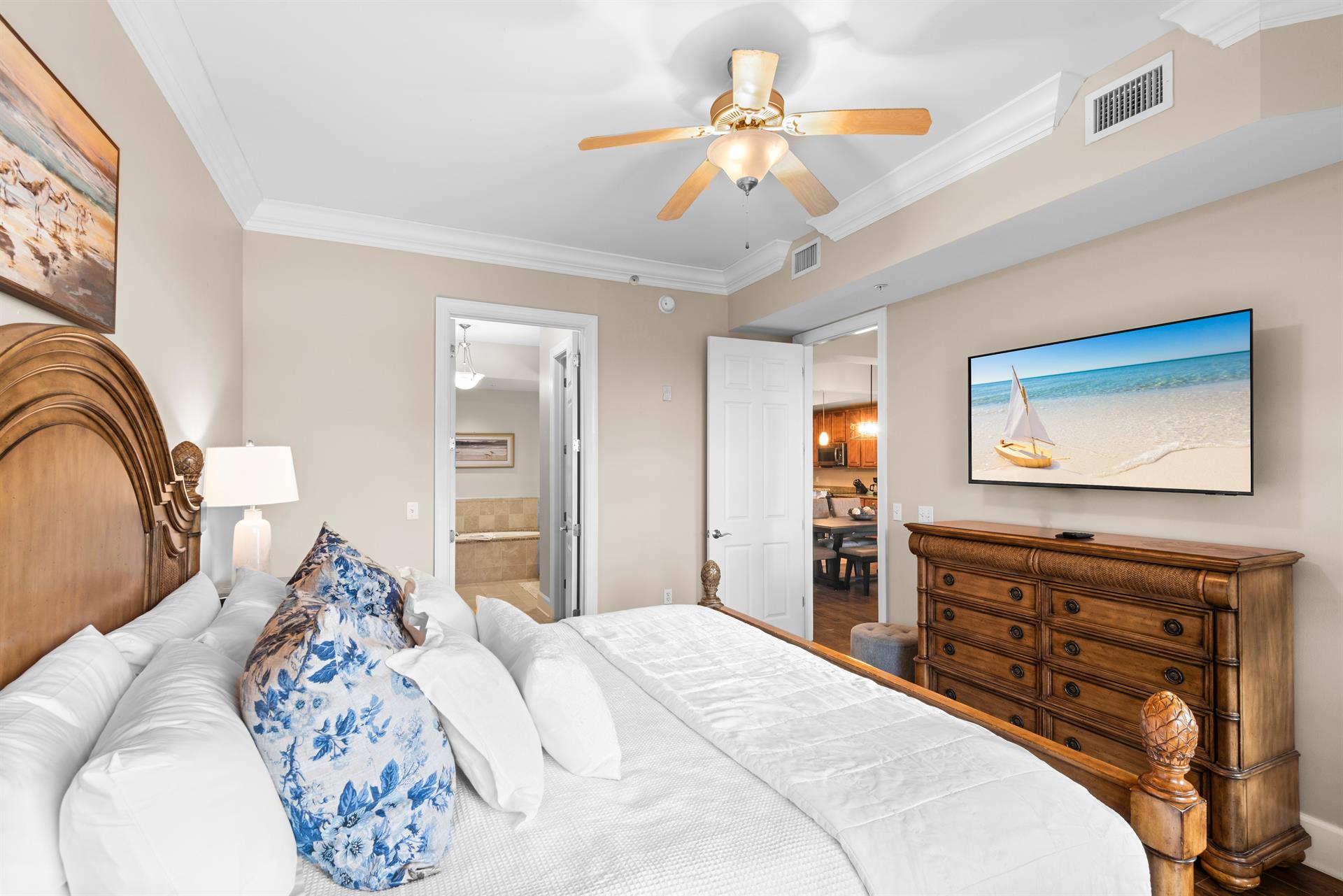 First floor king, coastalinspired bedroom, complete with plush bedding and soothing beach artwork.