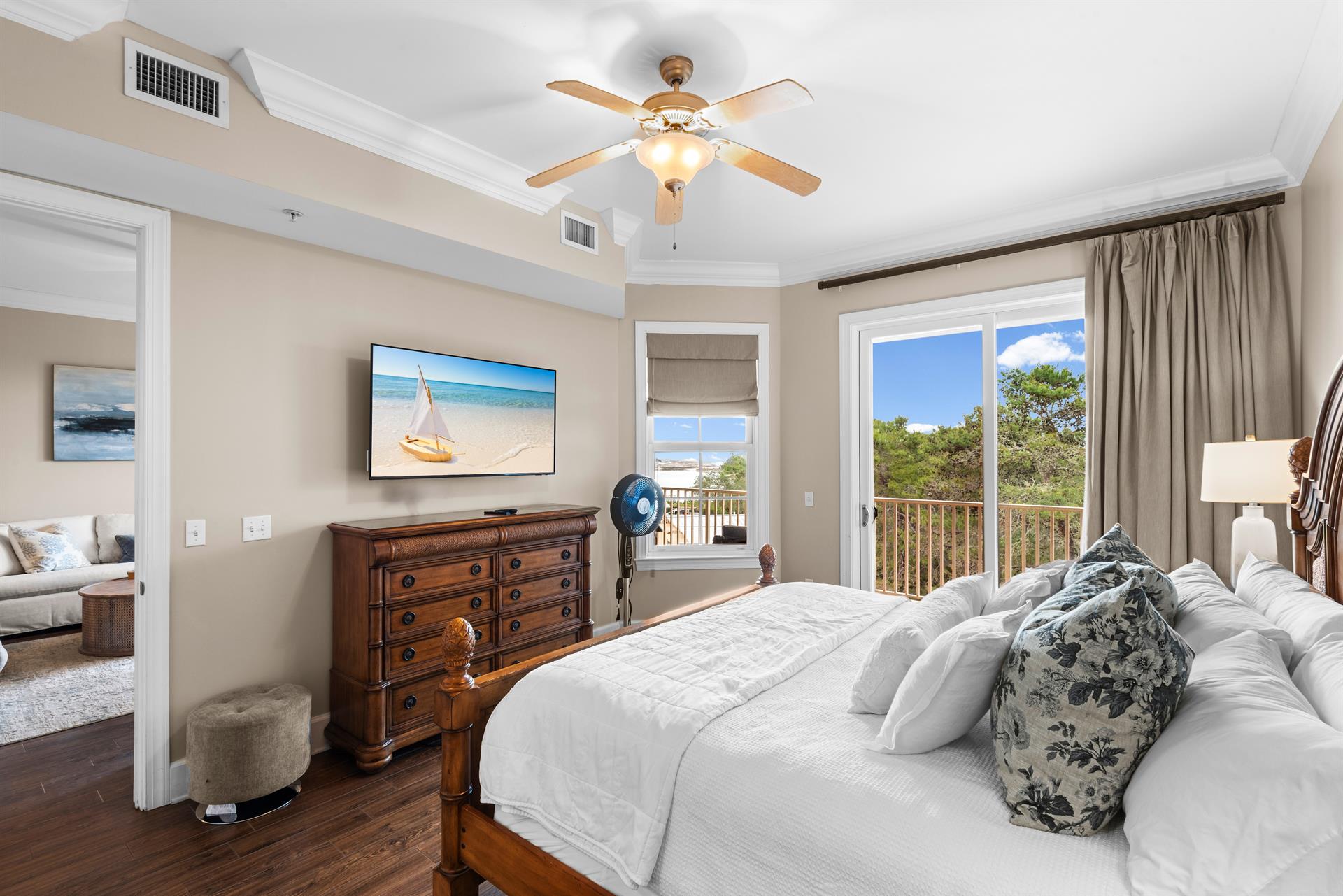 First floor king bedroom with tranquil views from your private balcony, complete with luxurious linens and coastal artwork.