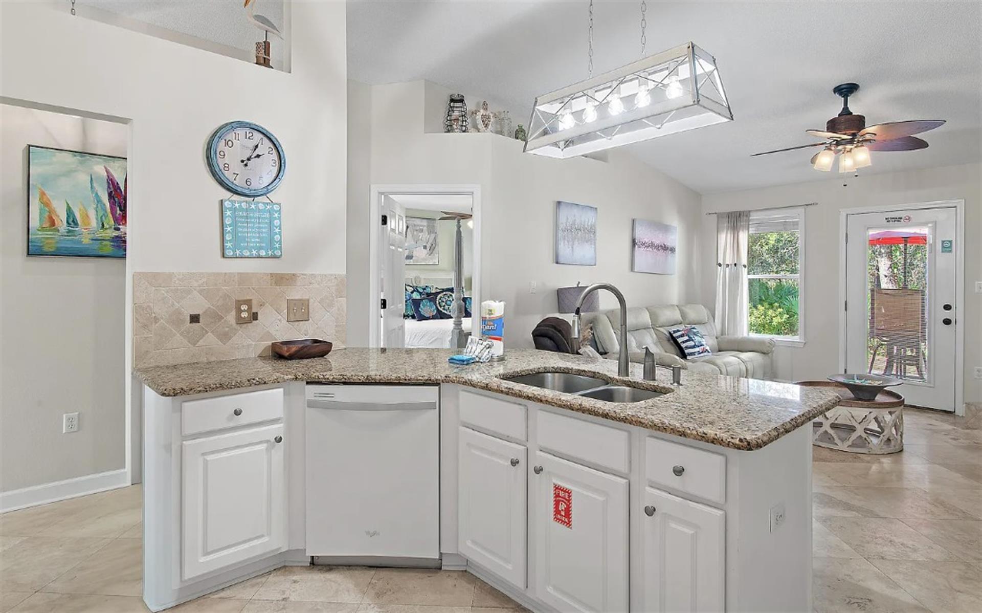 Whip up your morning coffee in this bright, open kitchen featuring granite counters and modern appliances, perfectly connected to your cozy living space.