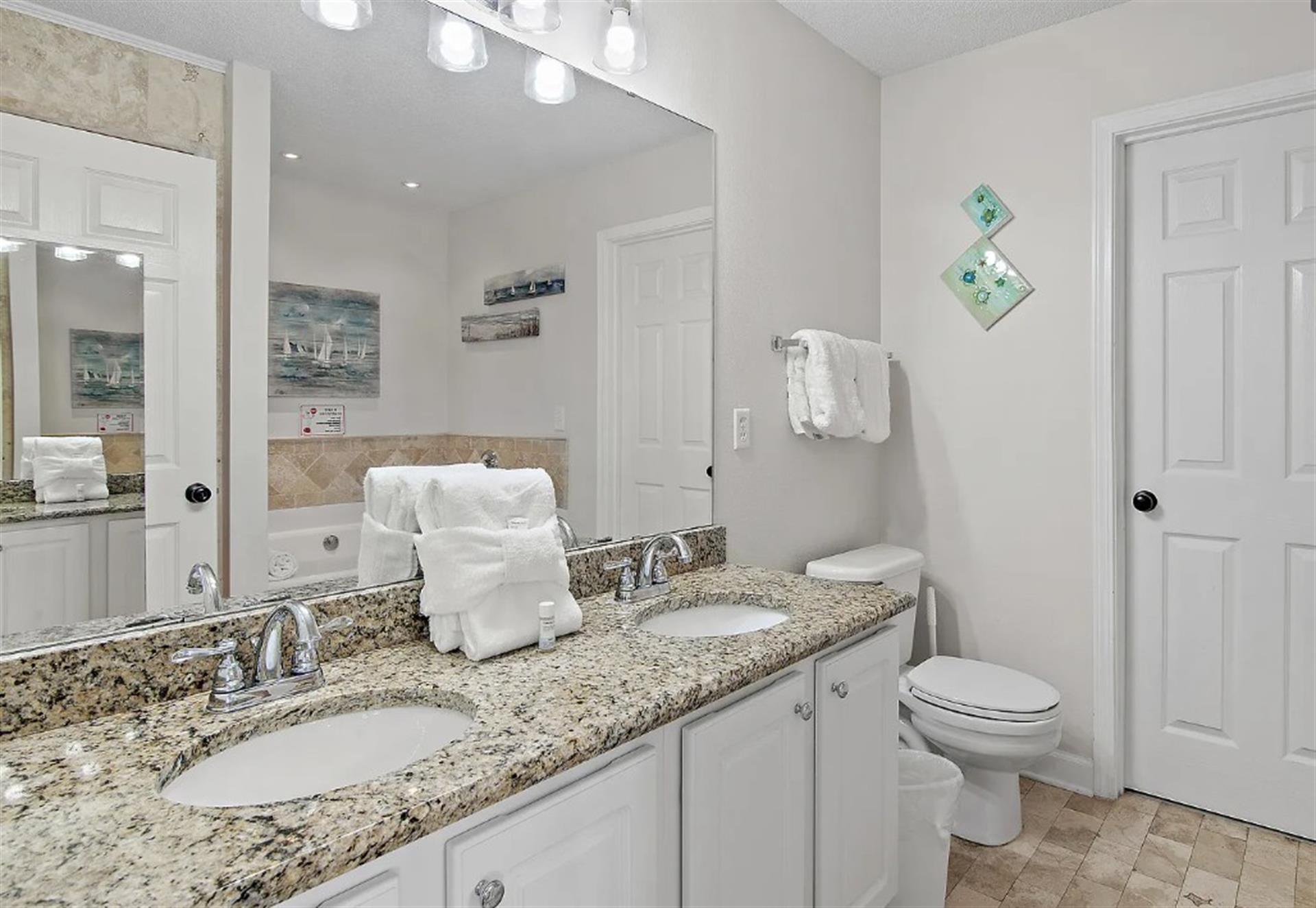Bathroom 1  Step into your bright bathroom featuring granite countertops, dual sinks, and fresh towels waiting for your arrival.