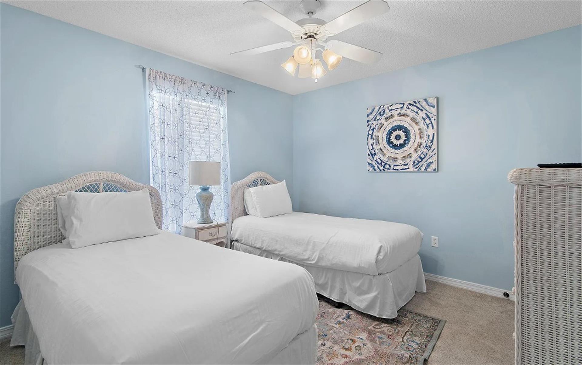 Bedroom 3  Drift off peacefully in your serene twin bedroom with soft blue walls and coastal charm.