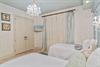 Elegant twin bedroom with crystal chandeliers and soft linens for restful nights.