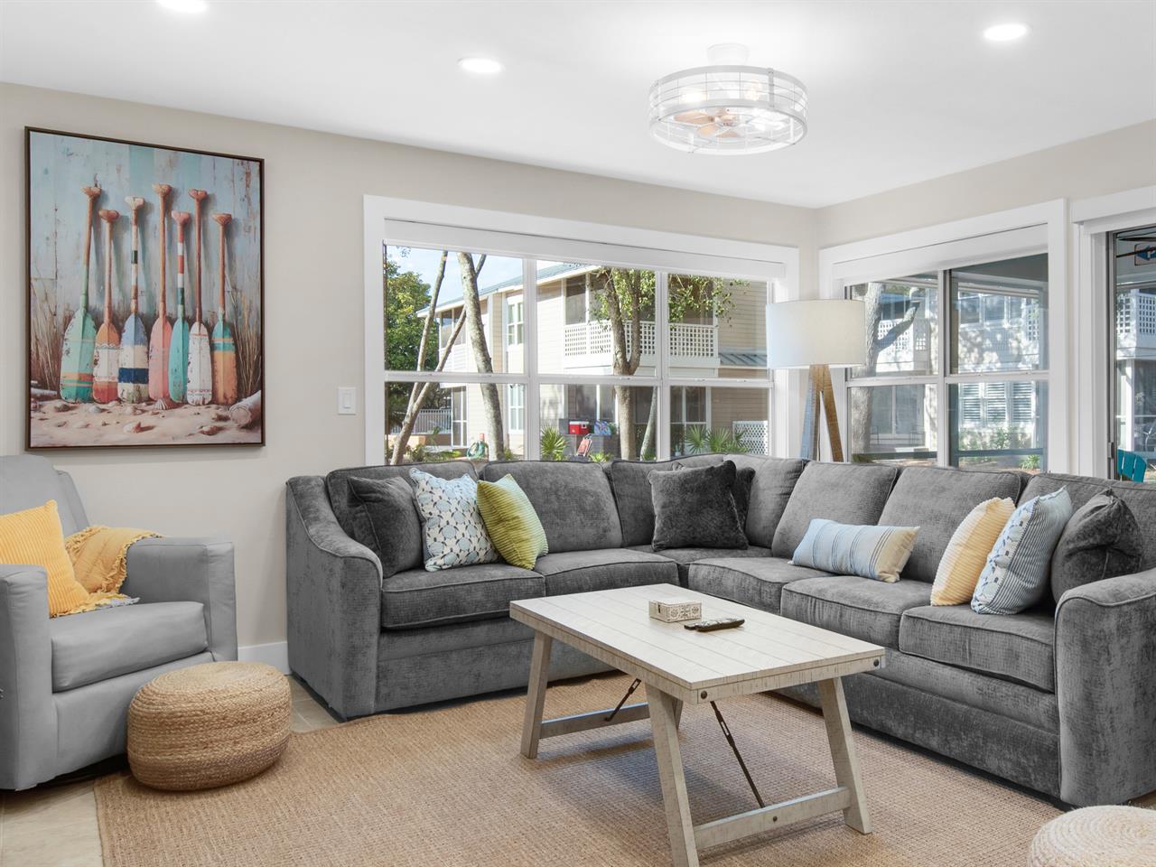 Sink into your spacious sectional sofa and enjoy the bright, airy living room with coastal charm and peaceful views.