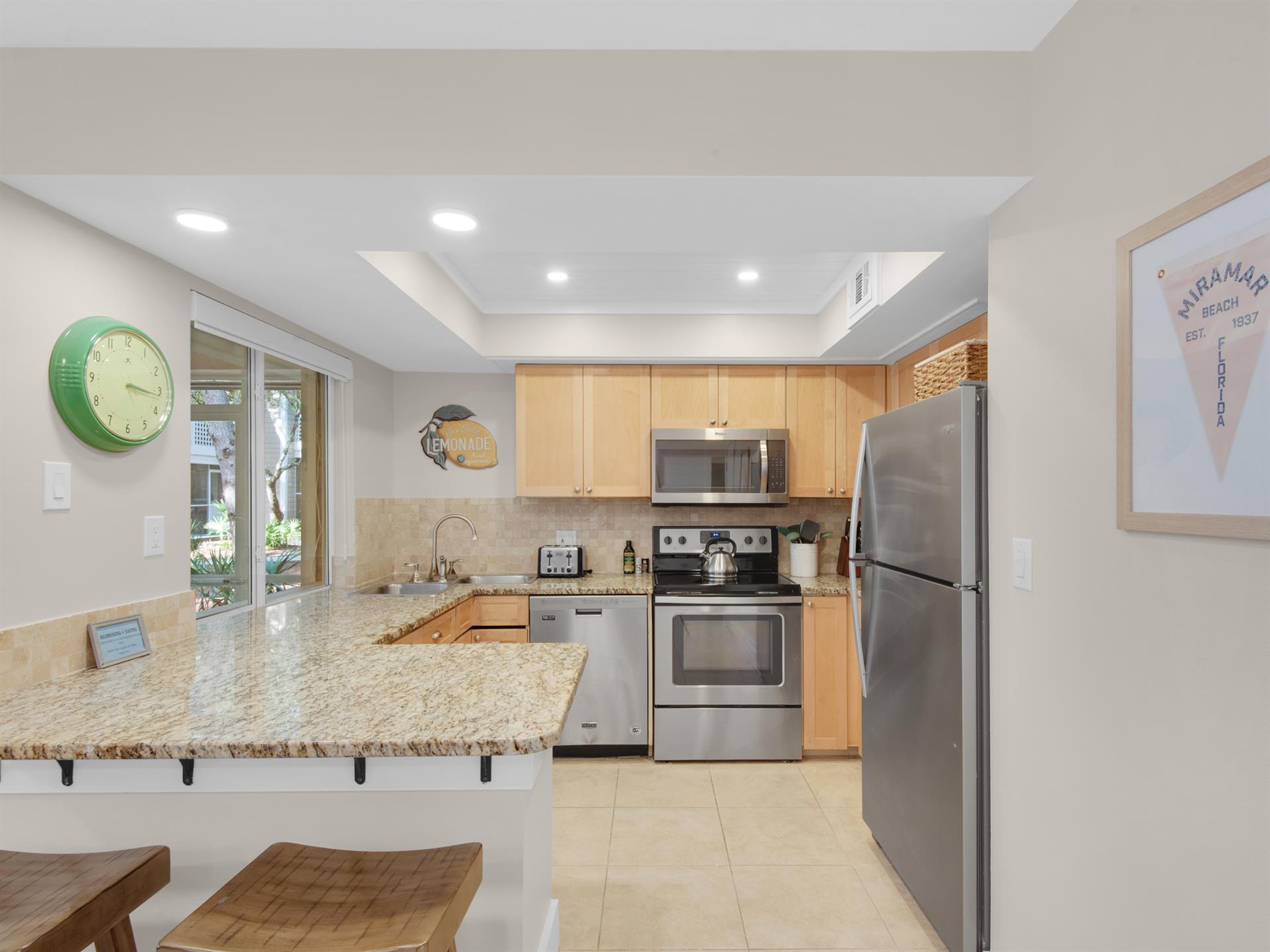 Your fullyequipped kitchen awaits with granite counters, stainless appliances, and breakfast bar seating for memorable meals