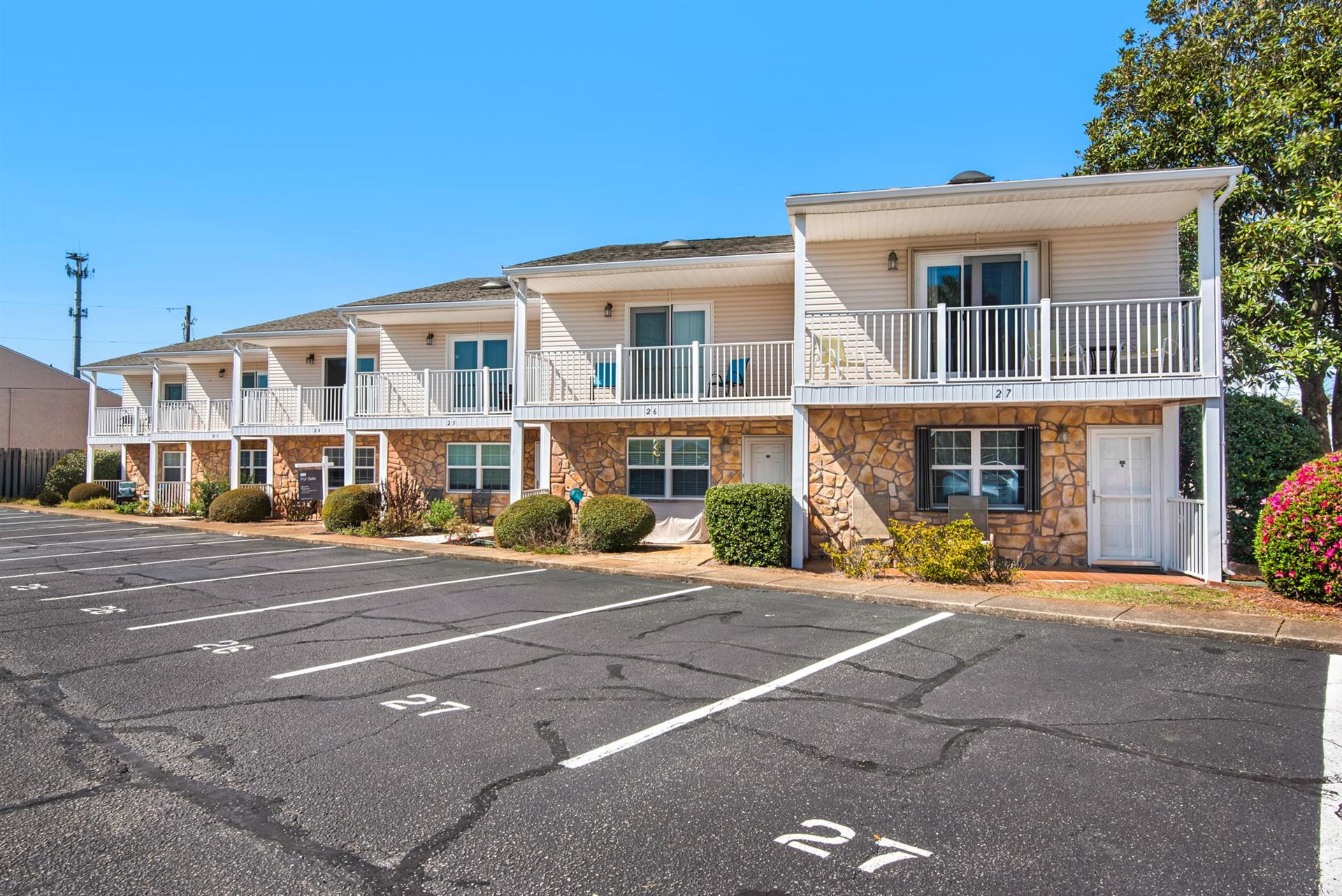 Twostory building with reserved parking spaces and landscaped grounds.