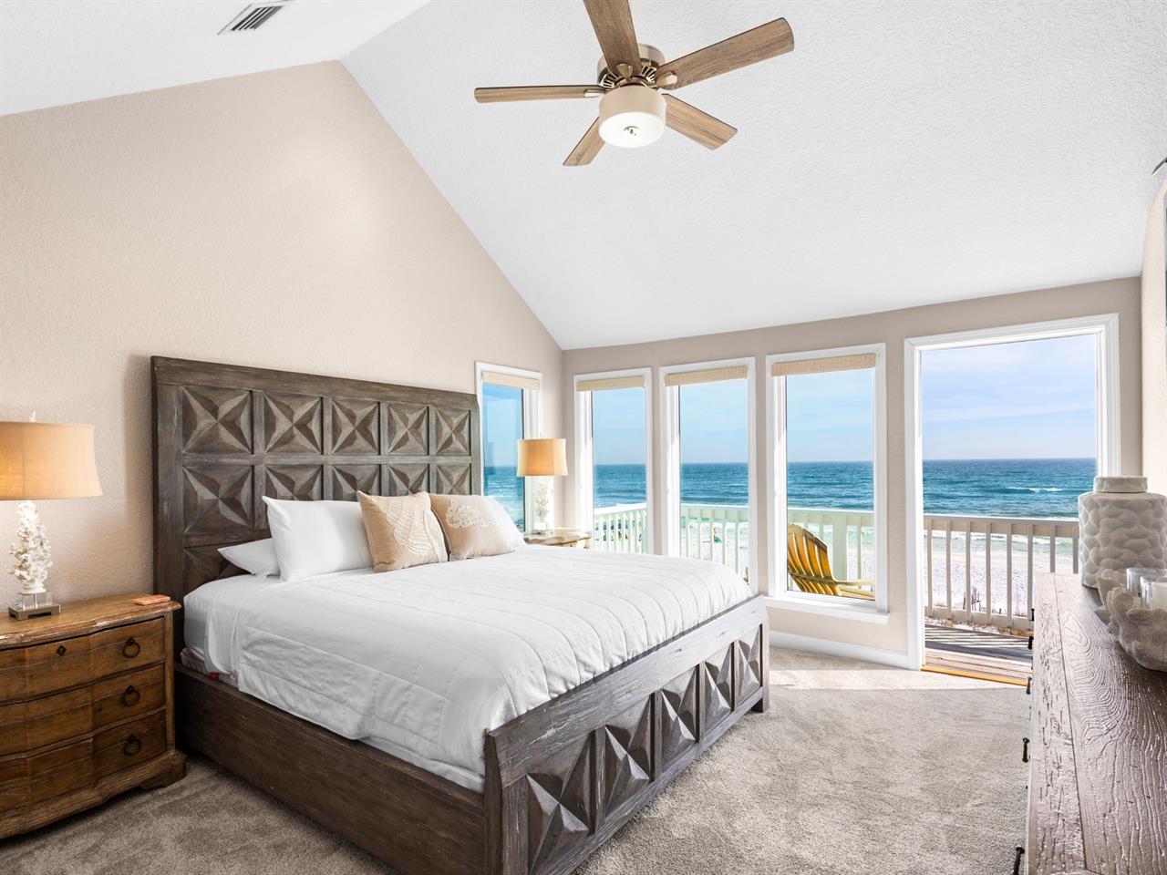 Bedroom 1  Wake to endless Gulf views from your comfortable bed, where gentle sea breezes flow through open doors to your private beach balcony.