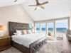 Bedroom 1  Wake to endless Gulf views from your comfortable bed, where gentle sea breezes flow through open doors to your private beach balcony.