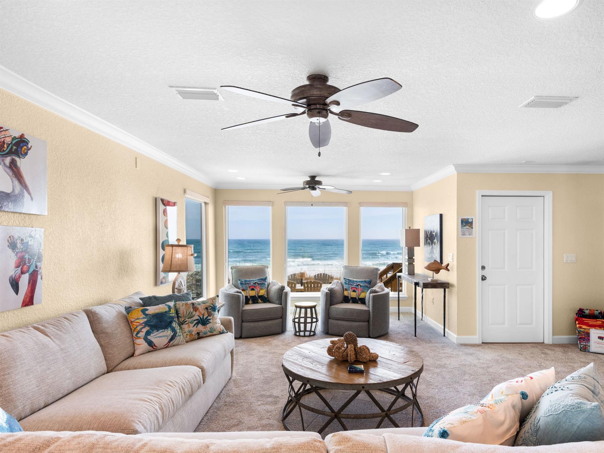 Wake up to breathtaking Gulf views from your comfortable living space, where coastal breezes flow through while you relax on plush seating.