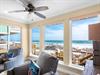 Relax in your comfortable living room while enjoying breathtaking beach views through expansive windows that bring the beach right to you.