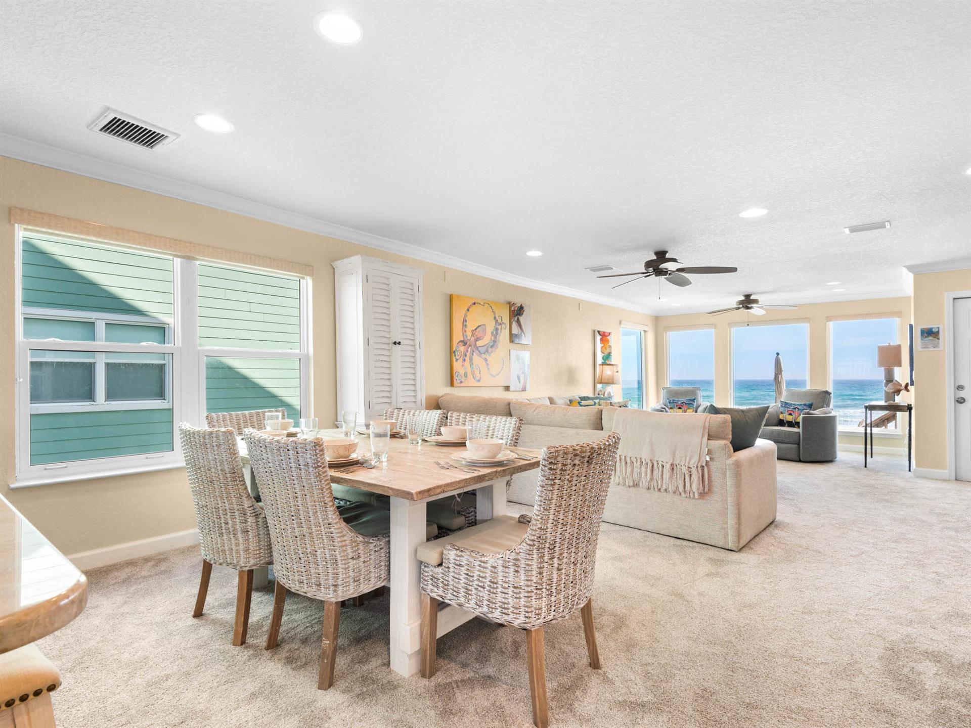 The spacious openconcept living area flows seamlessly from dining to lounge, with stunning ocean views through floortoceiling windows creating the perfect coastal retreat.
